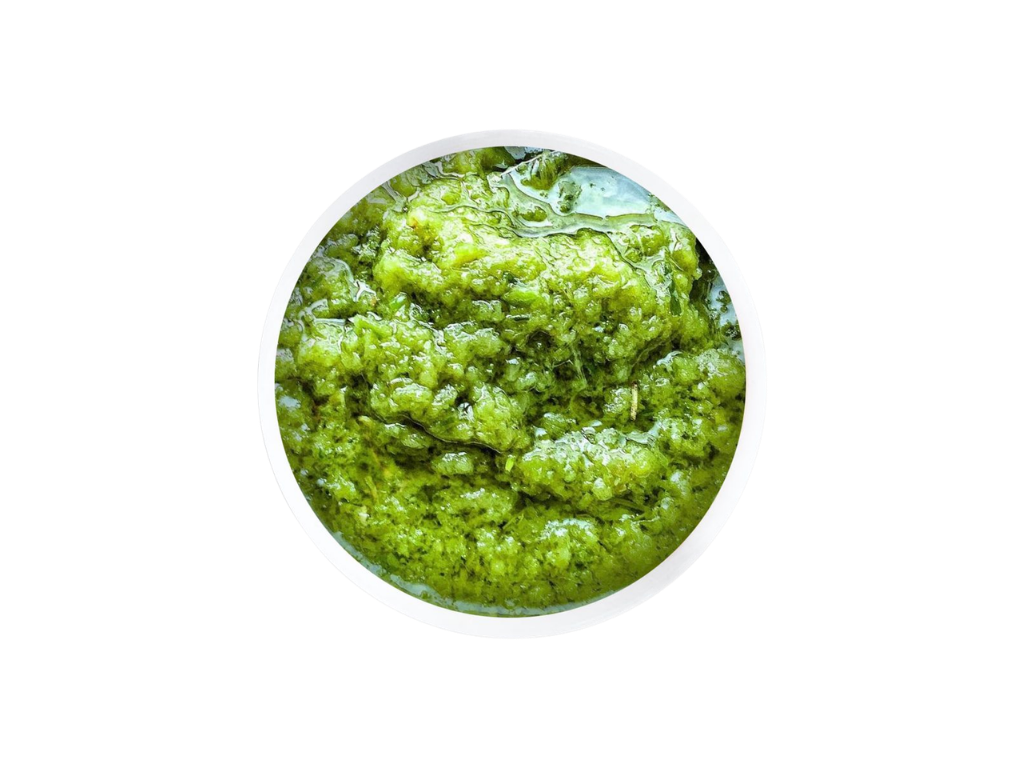 Close-up of green guacamole in a white bowl.