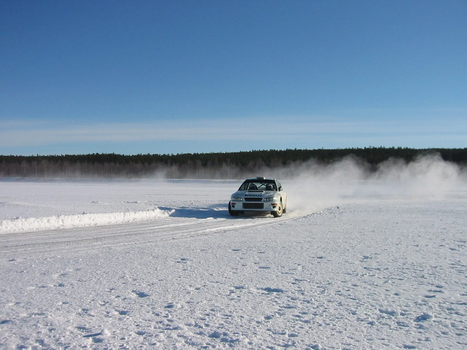 Rally car undergoing performance testing in snow conditions during vehicle development