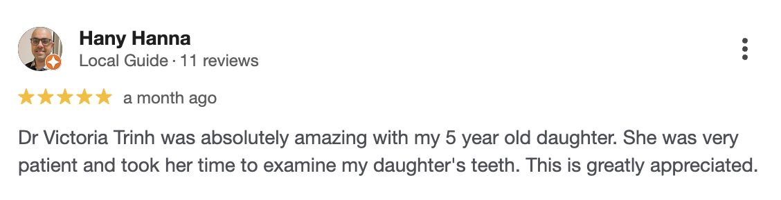 A screenshot of a Google review from Hany Hanna, a local guide, five-star rating, praising Dr. Victoria Trinh for her patience and care during her daughter's dental examination.