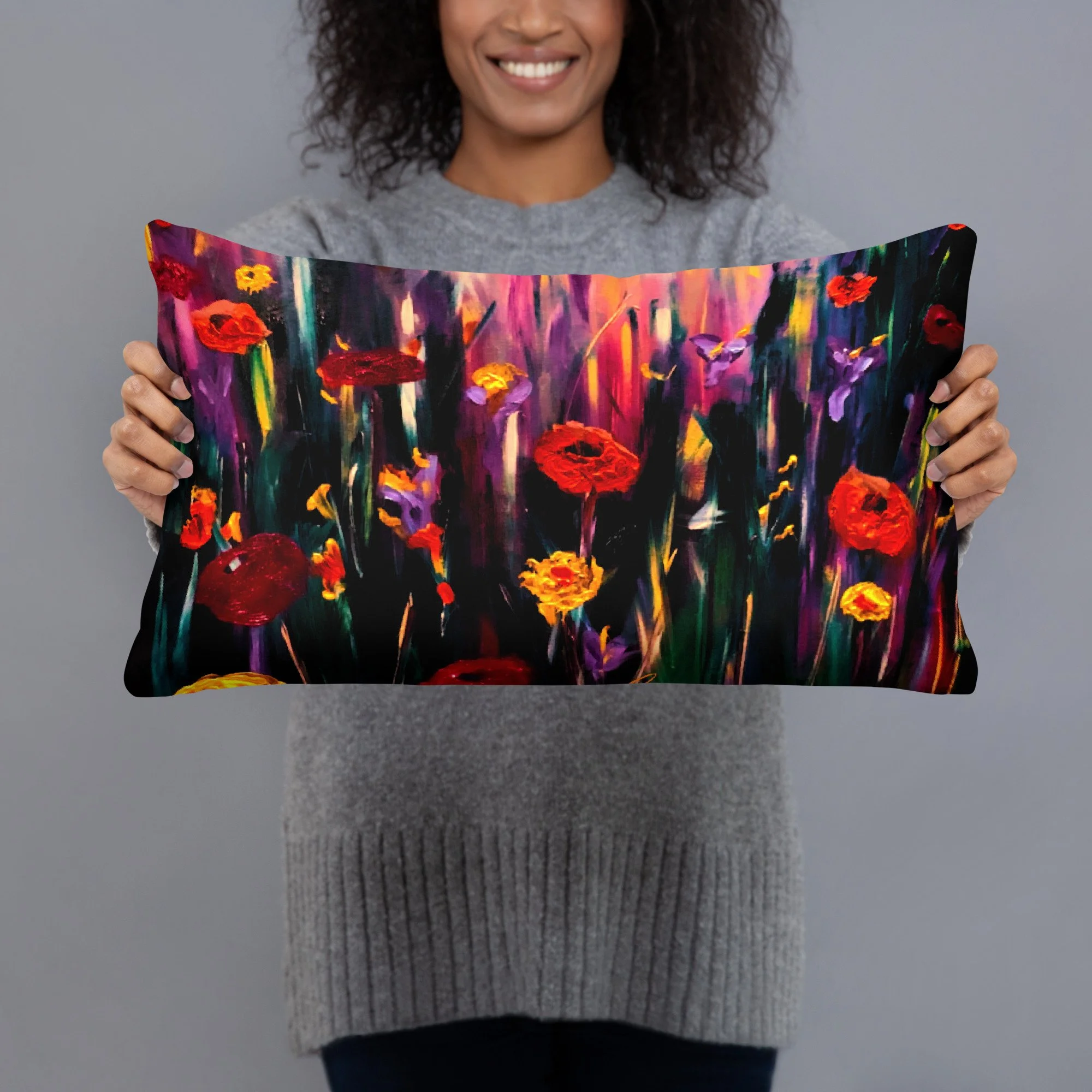 Woman holding a decorative cushion featuring vibrant poppy artwork with bold red and golden flowers, purple blooms and rich expressive colours on a dramatic botanical background.