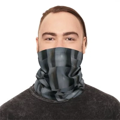 A man wearing a camouflage neck gaiter covering his nose and mouth, with a plain gray shirt.