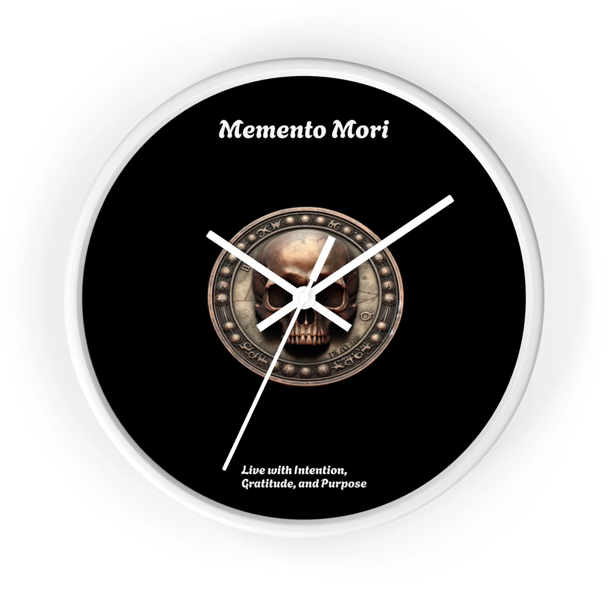 A round wall clock with a black background, featuring a central skull graphic surrounded by a decorative border. The clock has white hands and white text that reads 'Memento Mori' at the top and 'Live with Intention, Gratitude, and Purpose' at the bo