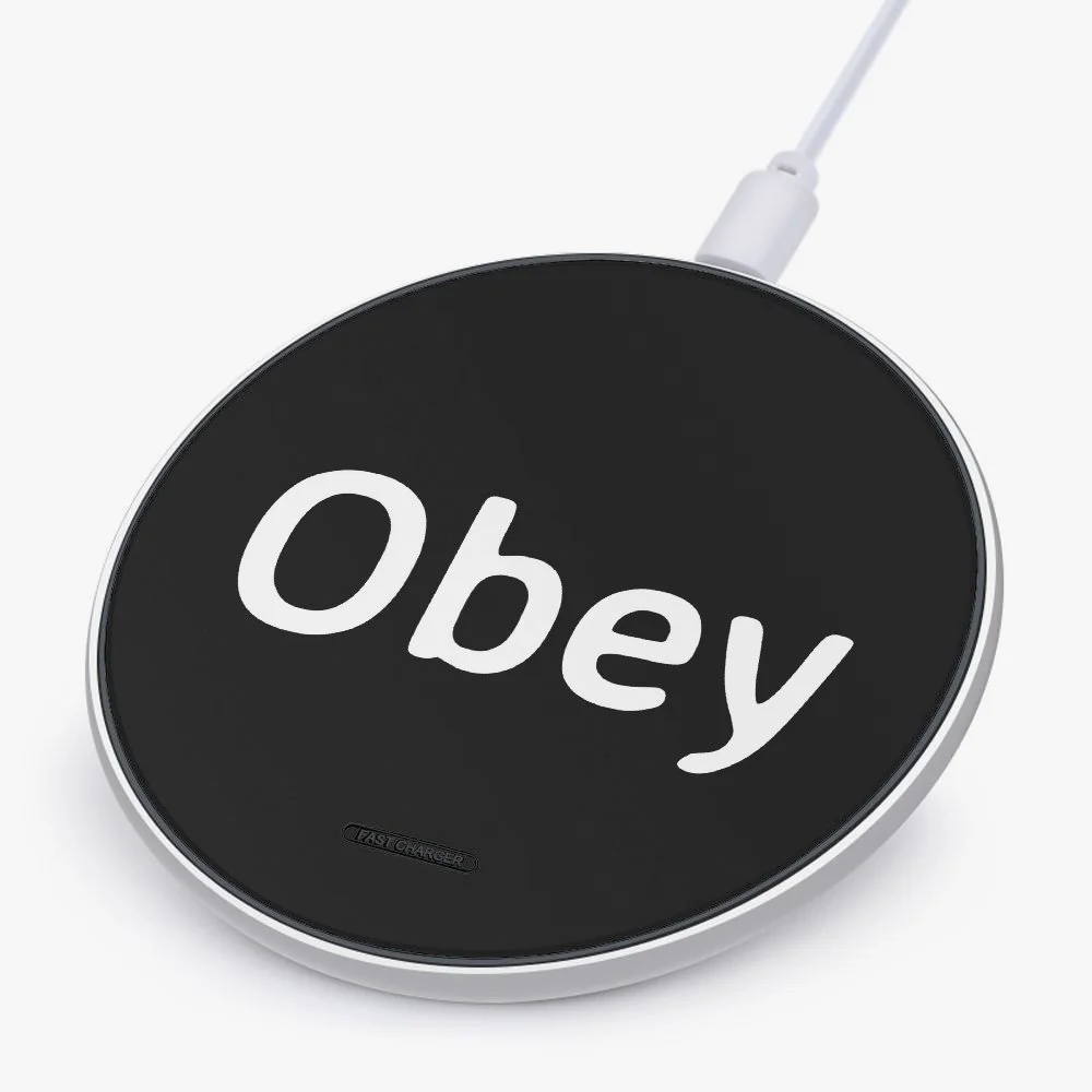 Wireless charger with the word 'Obey' written on its surface
