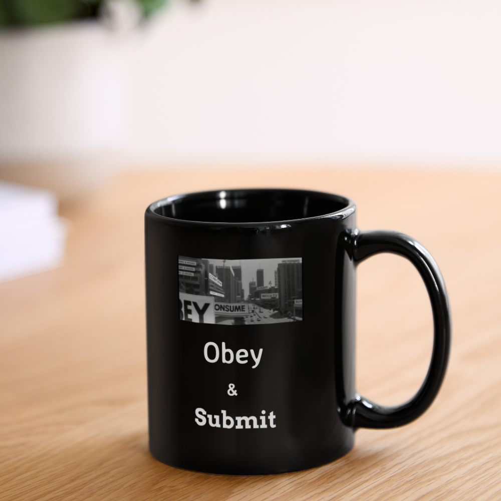 Black coffee mug on wooden table with a cityscape and the words 'Obey & Submit' printed on it.