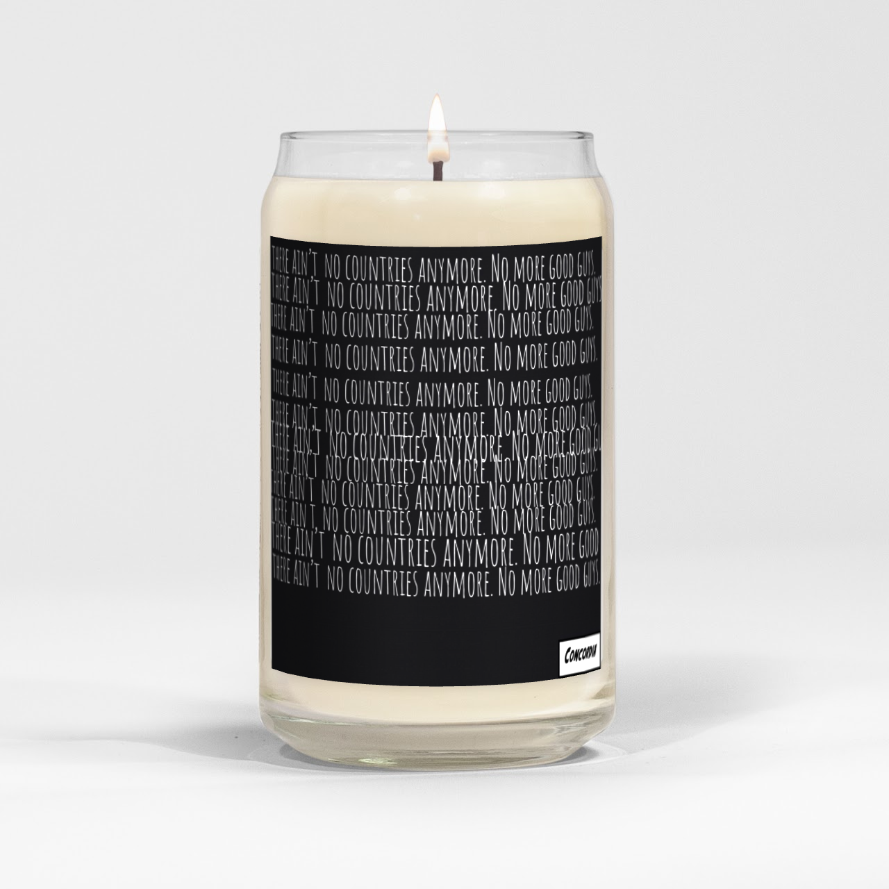 A white candle with a black label that reads 'There ain't no countries anymore. No more good guys.' repeated multiple times, with a small white logo at the bottom right corner.