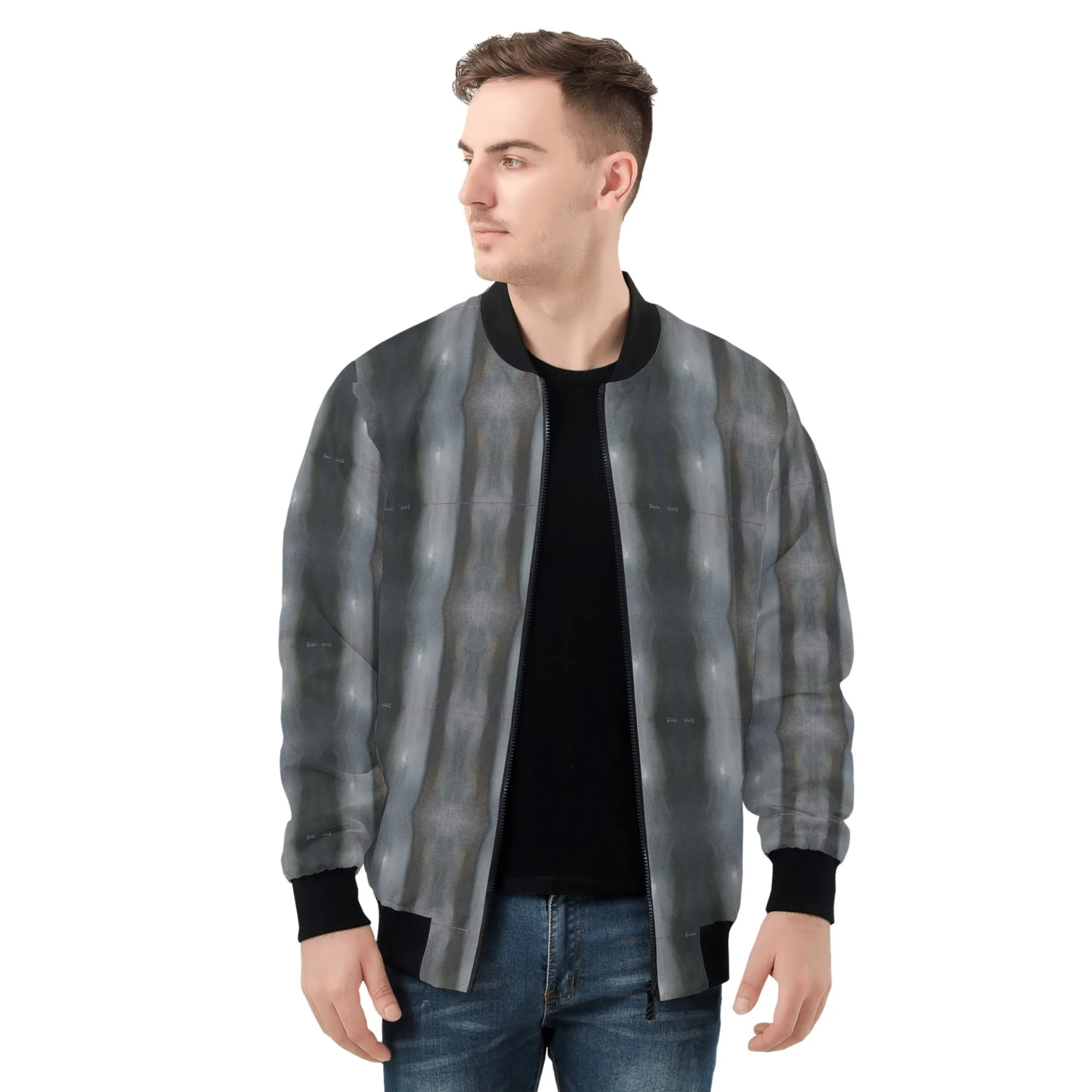 A young man wearing a patterned zip-up jacket with black cuffs and collar, a black T-shirt, and blue jeans, standing against a white background.