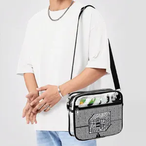 Person wearing a white oversized T-shirt with a black and white checkered shoulder bag featuring a small graphic on the front.
