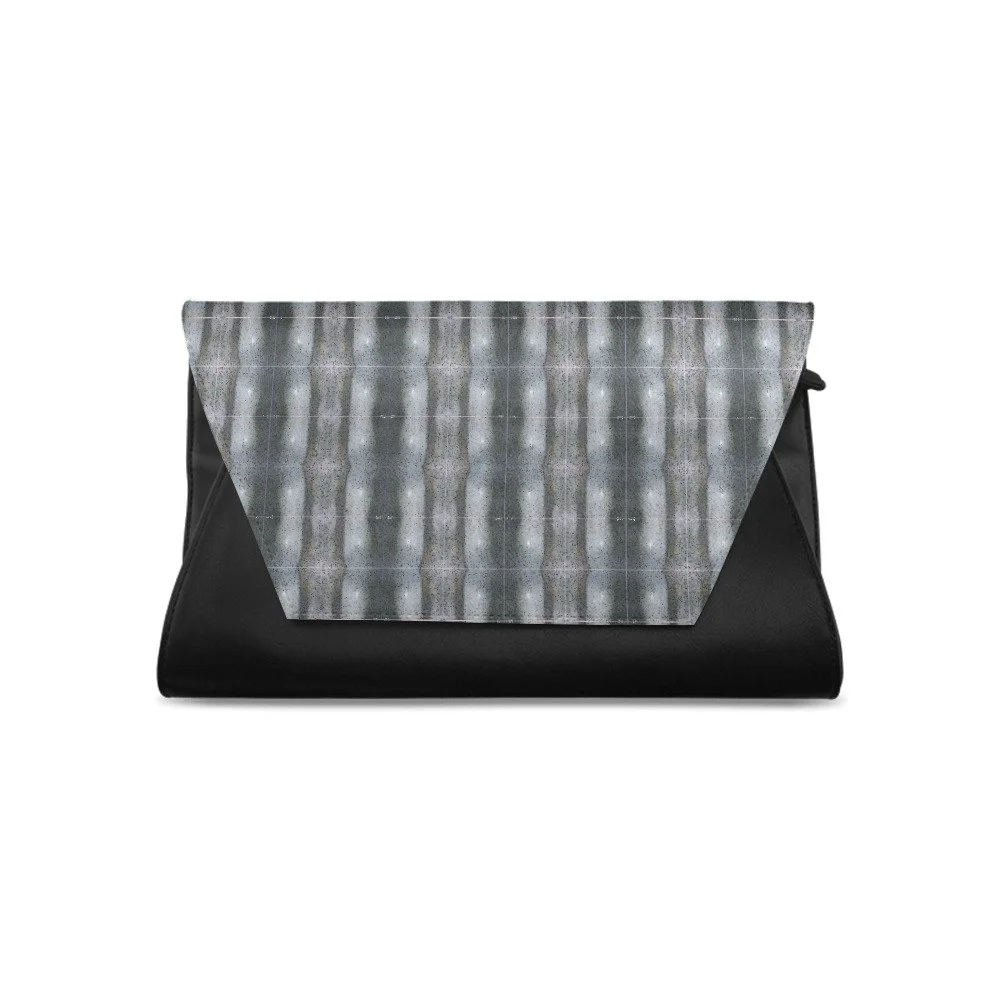 Black handbag with geometric patterned flap in shades of gray and white.