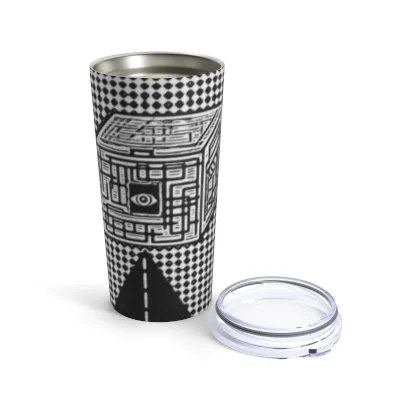 A tumbler with black and white geometric patterns and an eye design, placed beside a clear plastic lid.