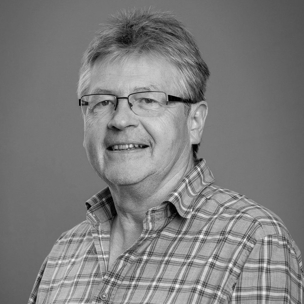 a black and white photo of Adam Fotherington, leadership coach at OMA.