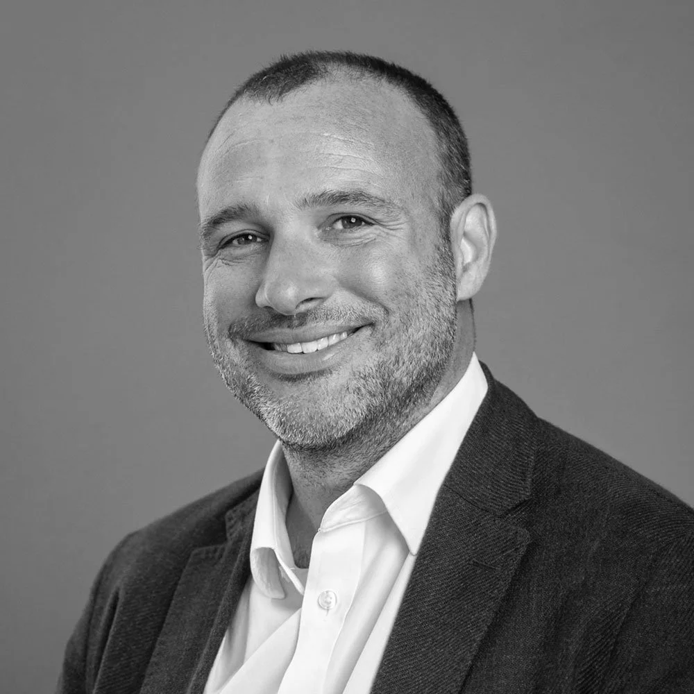 a black and white photo of Nathan Roberts, Managing Partner at OMA.