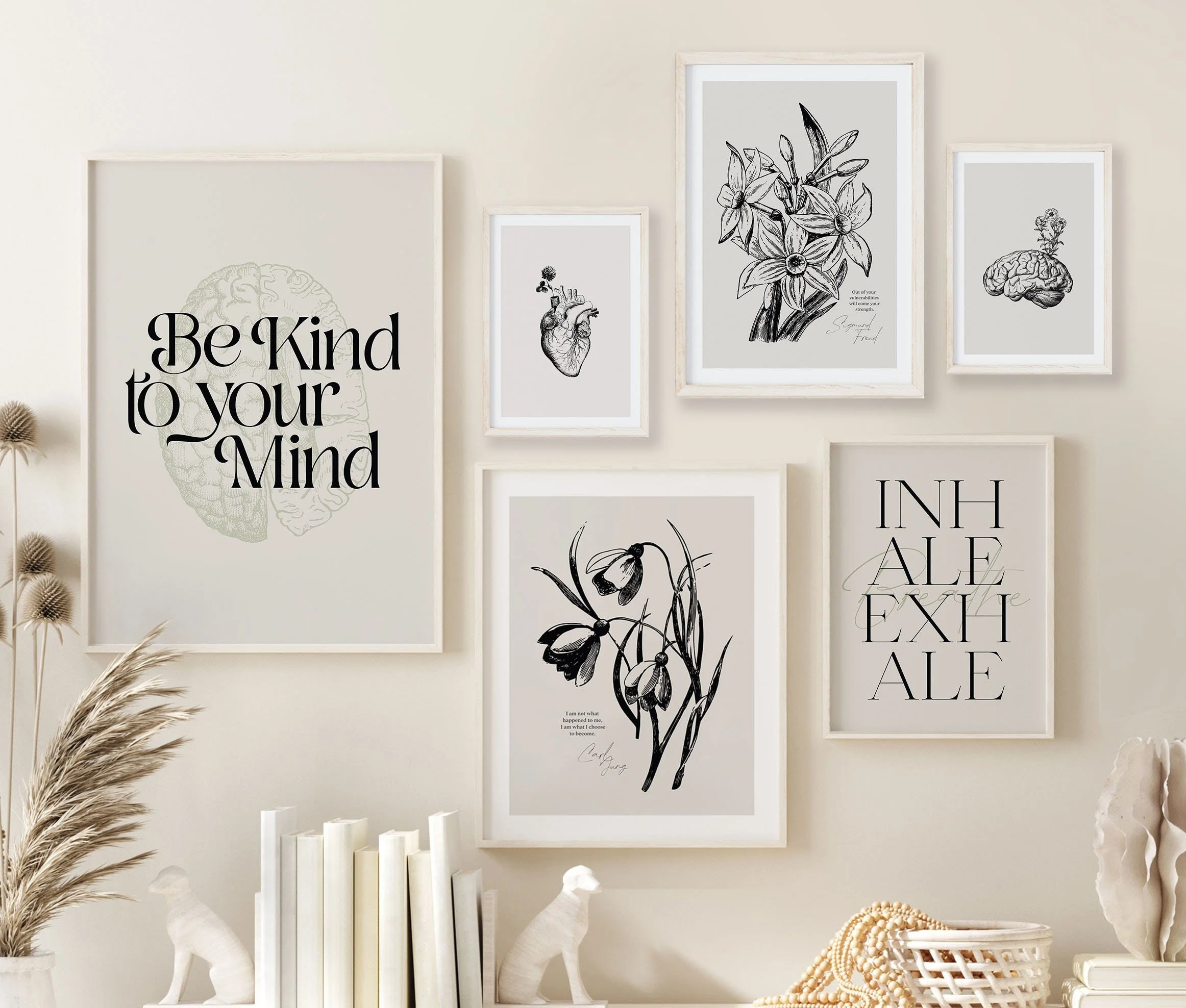 A wall with a gallery of framed artwork, including sketches of a brain, a heart, flowers, and a fish, with motivational and nature-themed quotes in black and white.