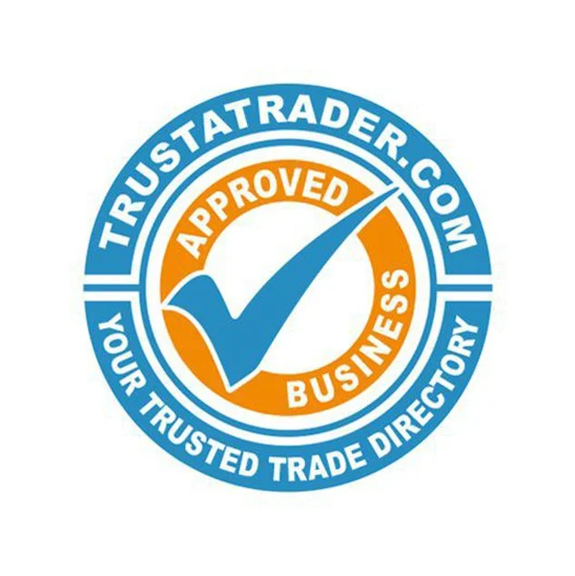 Trustatrader.com approved badge featuring a large blue checkmark and the words "Approved Business" in orange surrounding the checkmark, with a blue circular border stating "Your Trusted Trade Directory."