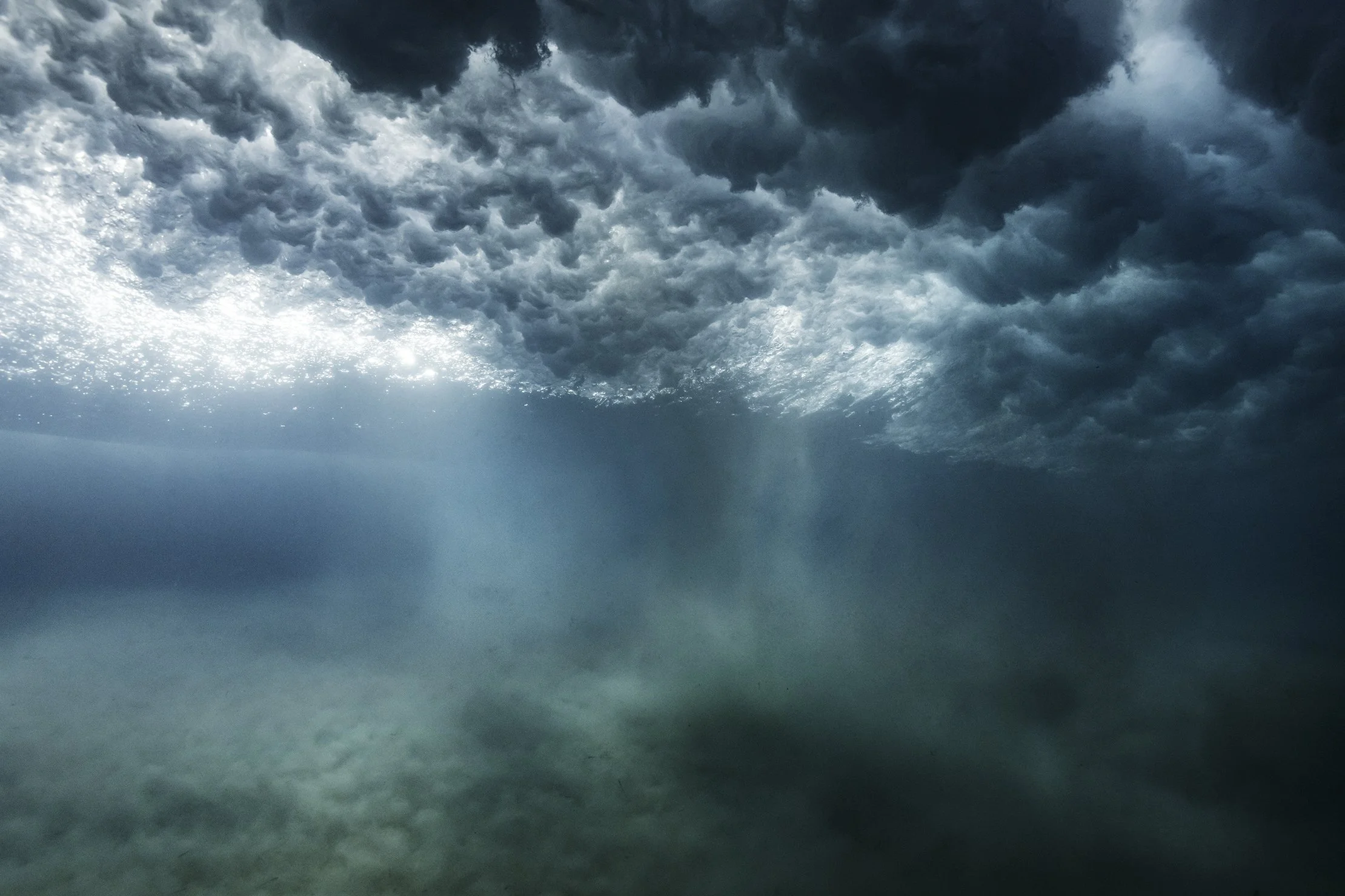 Underwater view of turbulent ocean waves with sunlight filtering through