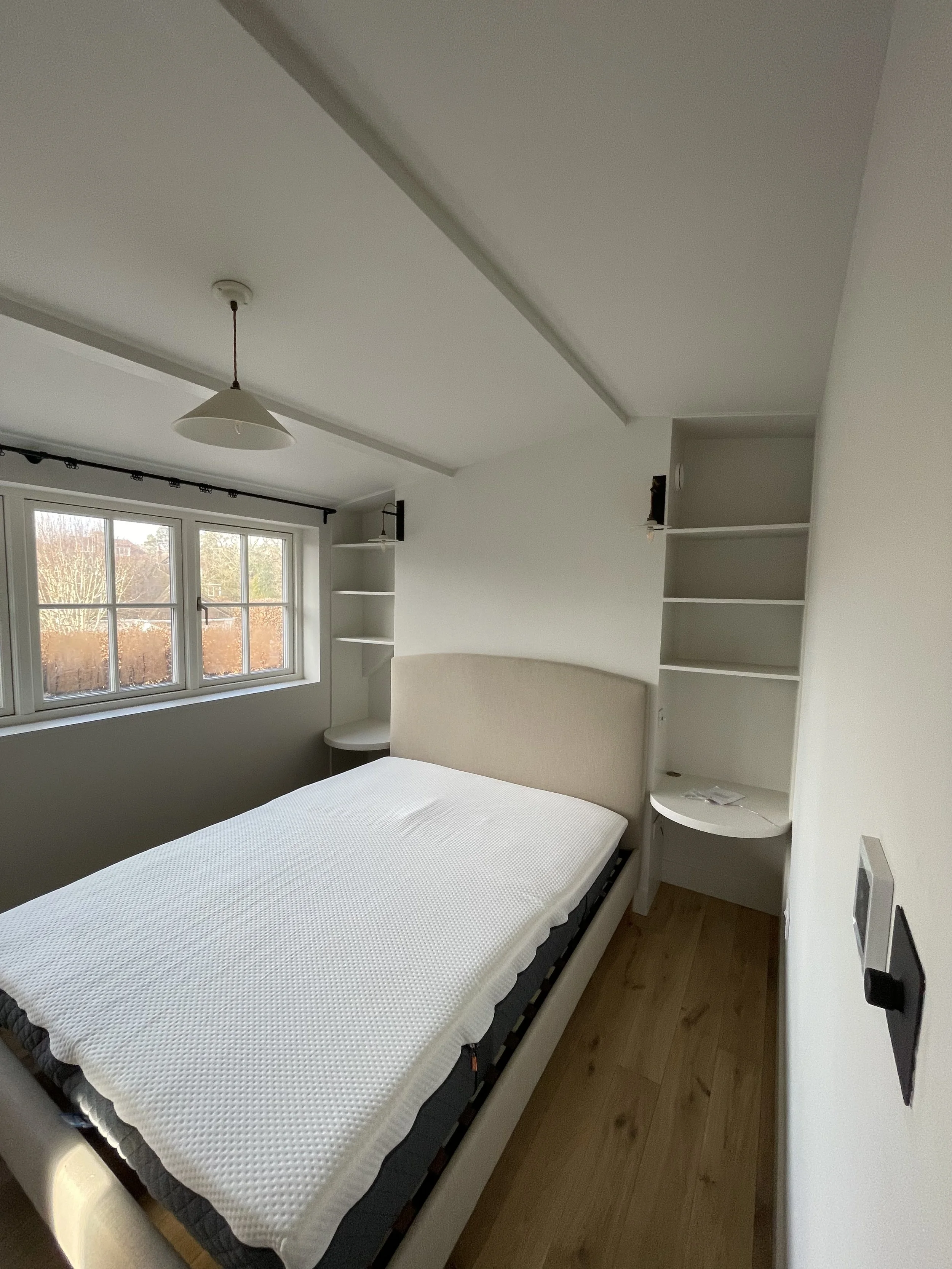 A new bedroom has been painted in colours from Paint and Paper Library. The woodwork is intelligent eggshell and the walls are Architectural Matt. The shelves are seamless with the headboard wall. 