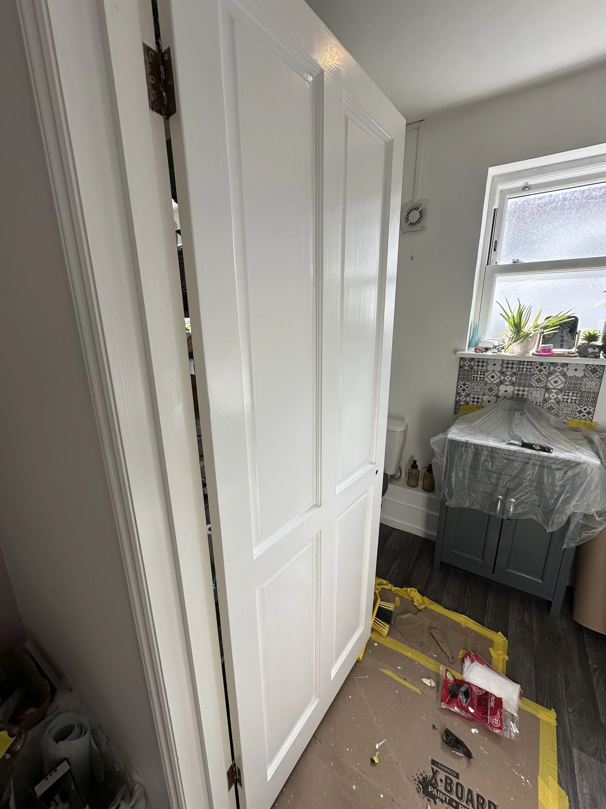 A bathroom door has been redecorated, prepped and painted in a bathroom as part of a full redecorating of a 2 bedroom house in Kemptown, Brighton. 