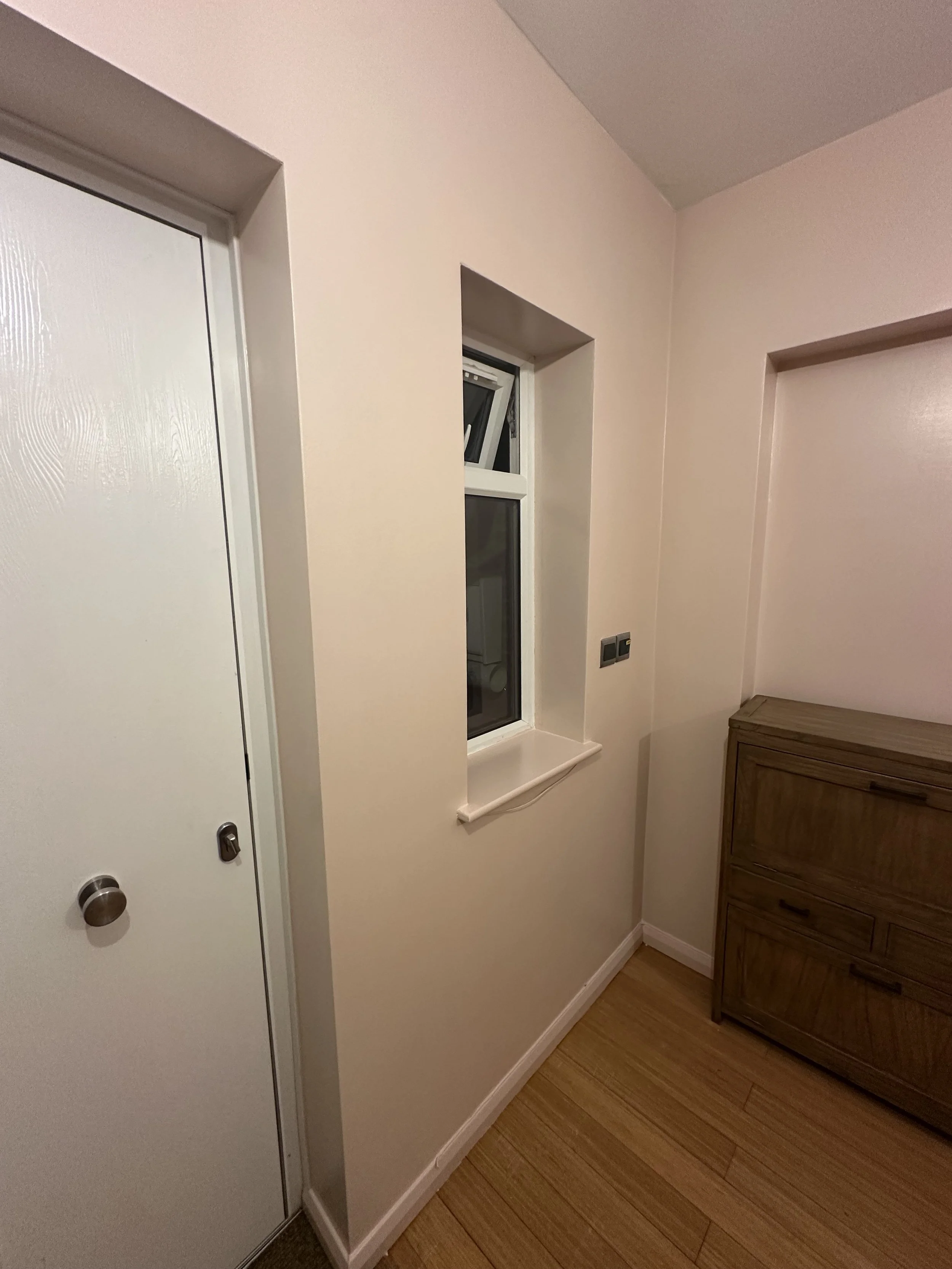 Entrance hallway redecration with a white uPVC door. The walls are a Farrow and Ball pink with a silk finish, the ceiling is AF1 by Albany, and the woodwork is the same F&B colour in a satin finish.