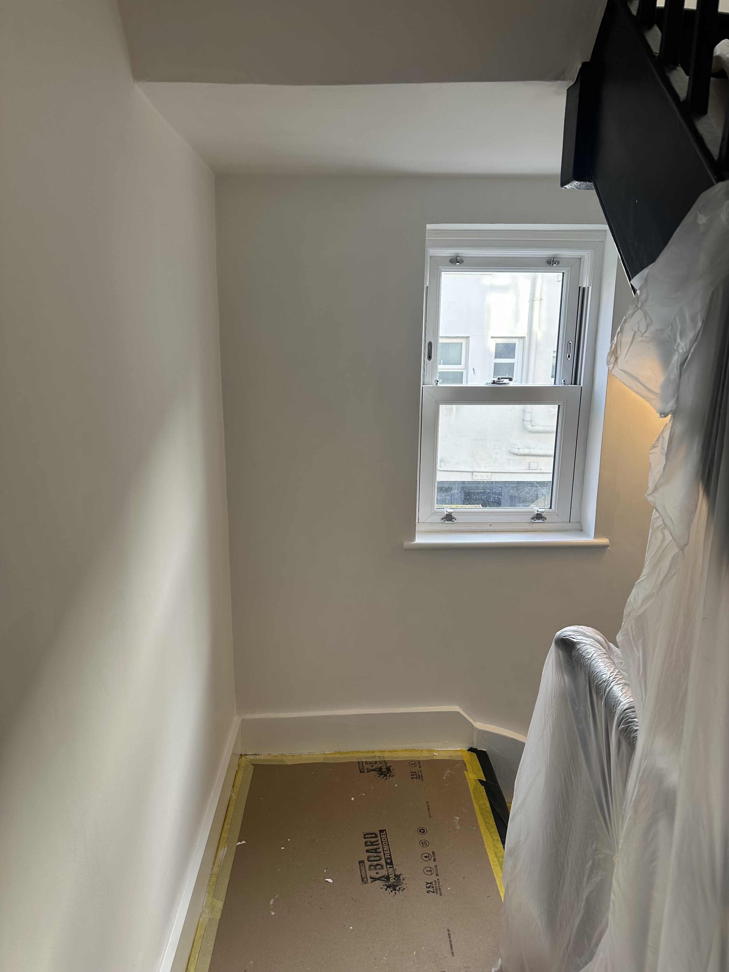 Hallway damp-sealed and painted, floor protection and spindle/bannister protection for a house which has damp issues due to bungaroosh being the primary building material for the walls. 