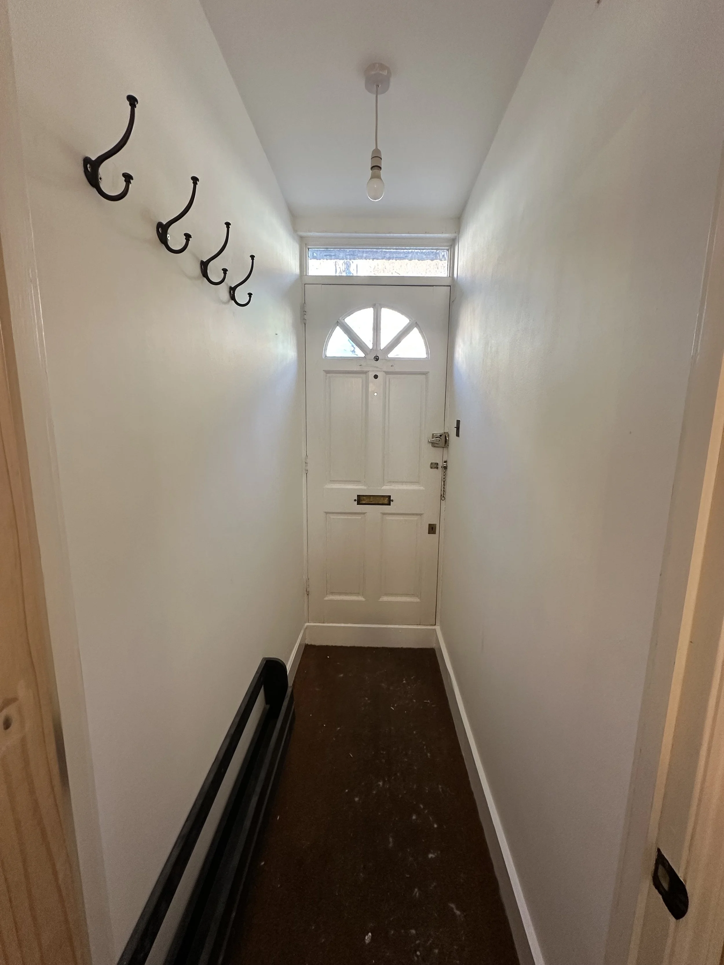 A refresh of an entrance hallway, where Farrow and Ball 'Wimborne' white was used on the walls and ceiling, and the same colour in Eggshell for the skirting boards. The door is white but wasn't painted as part of the works