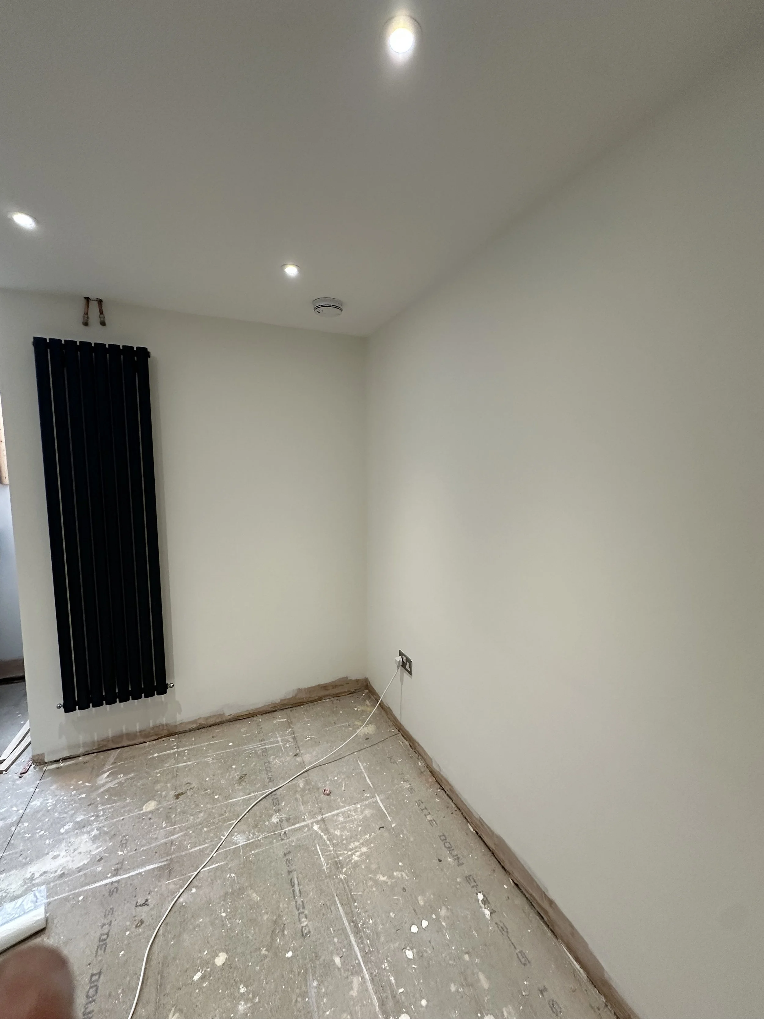 Corner of a basement room, the ceiling of which is painted in AF1 by Albany. The remainder of which is painted in Wimborne White by Farrow and Ball. 