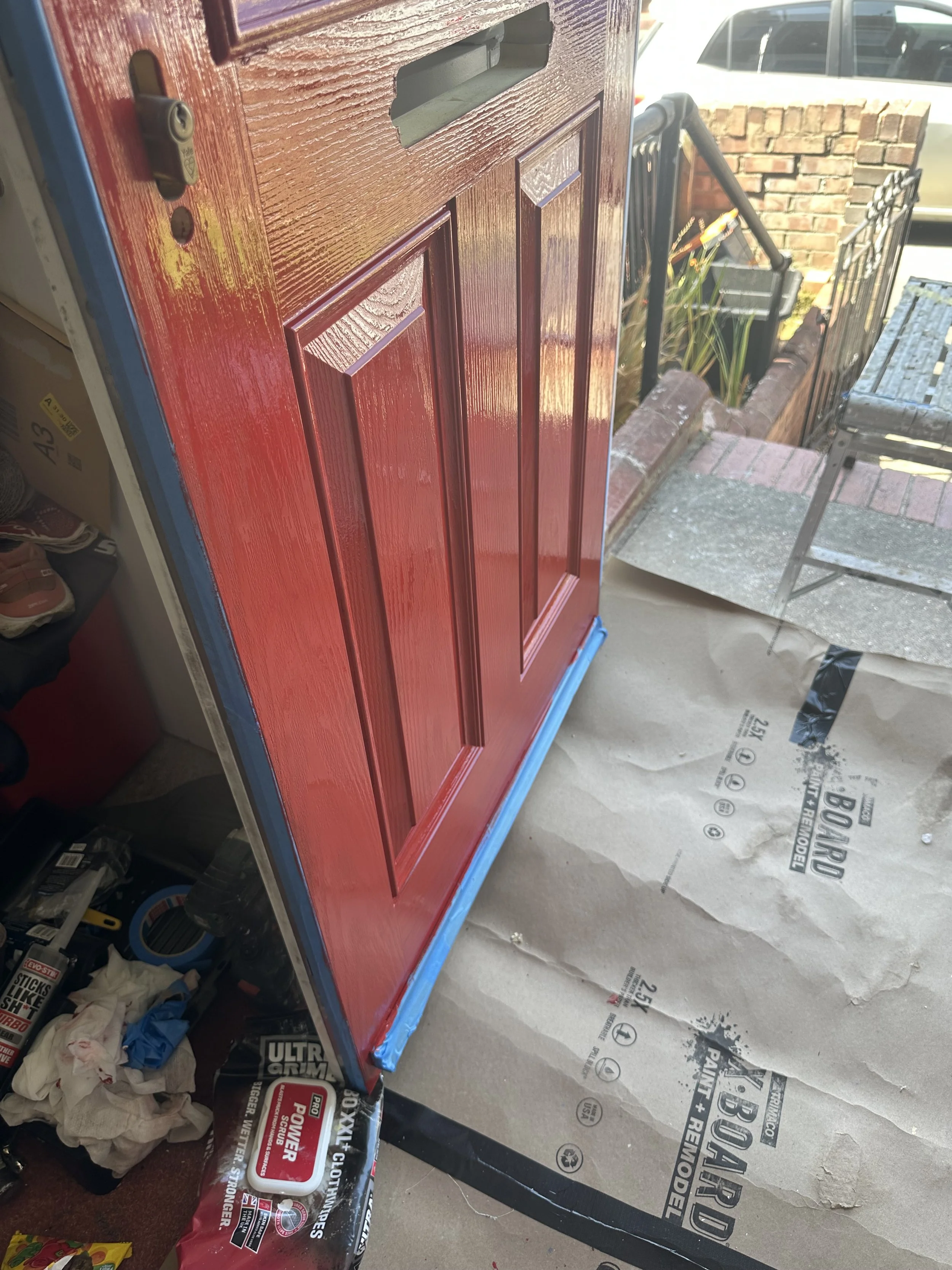 Lower half of uPVC door primed and painted in  Postbox red. Zinsser All-Coat was used so that 2 coats could be applied in a day. Metalwork was carefully removed prior painting. 