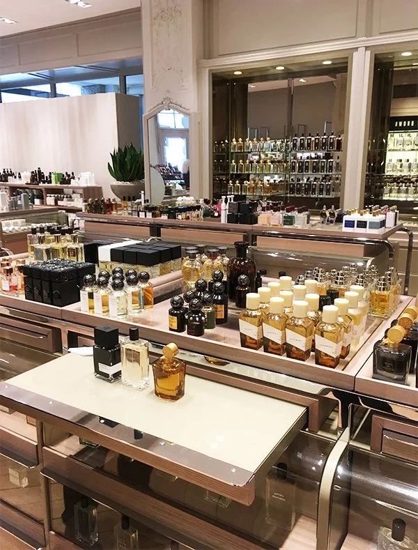 Display of various perfume bottles in a retail store.