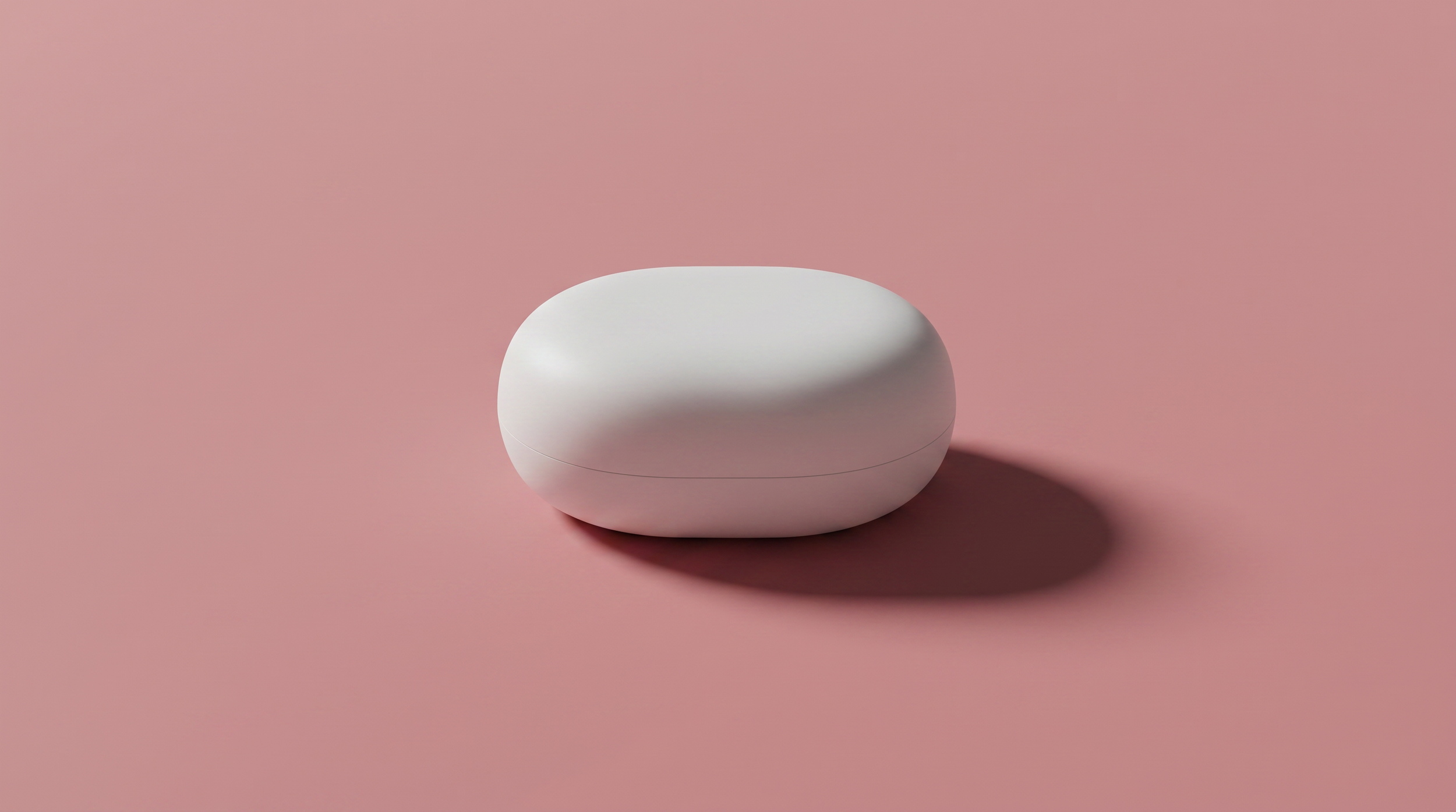 A sleek, white, oval-shaped container with a lid, placed on a pink background, casting a shadow.