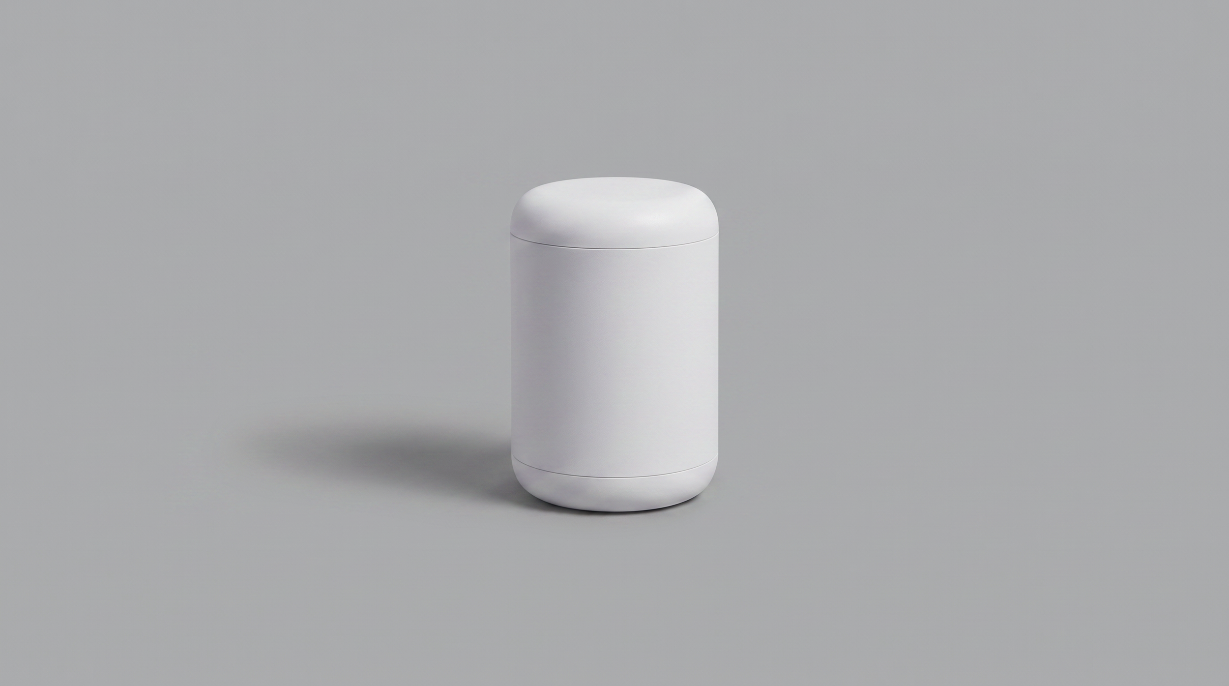 A sleek white cylindrical container with a rounded top and bottom, set against a plain light gray background.