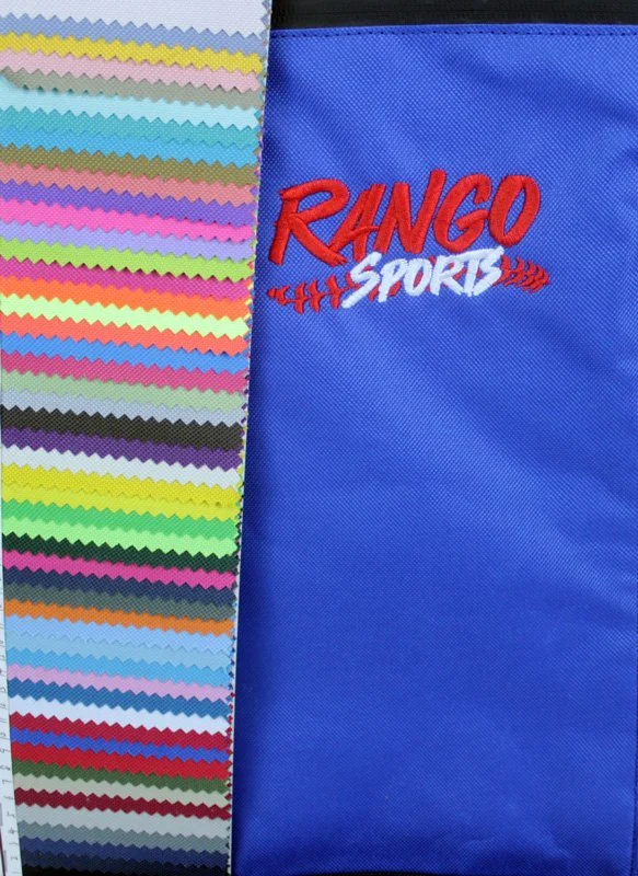 A fabric sample with colorful, zigzag-edged swatches on the left and a blue cloth with red lettering 'RANGO SPORT' embroidered on the right.