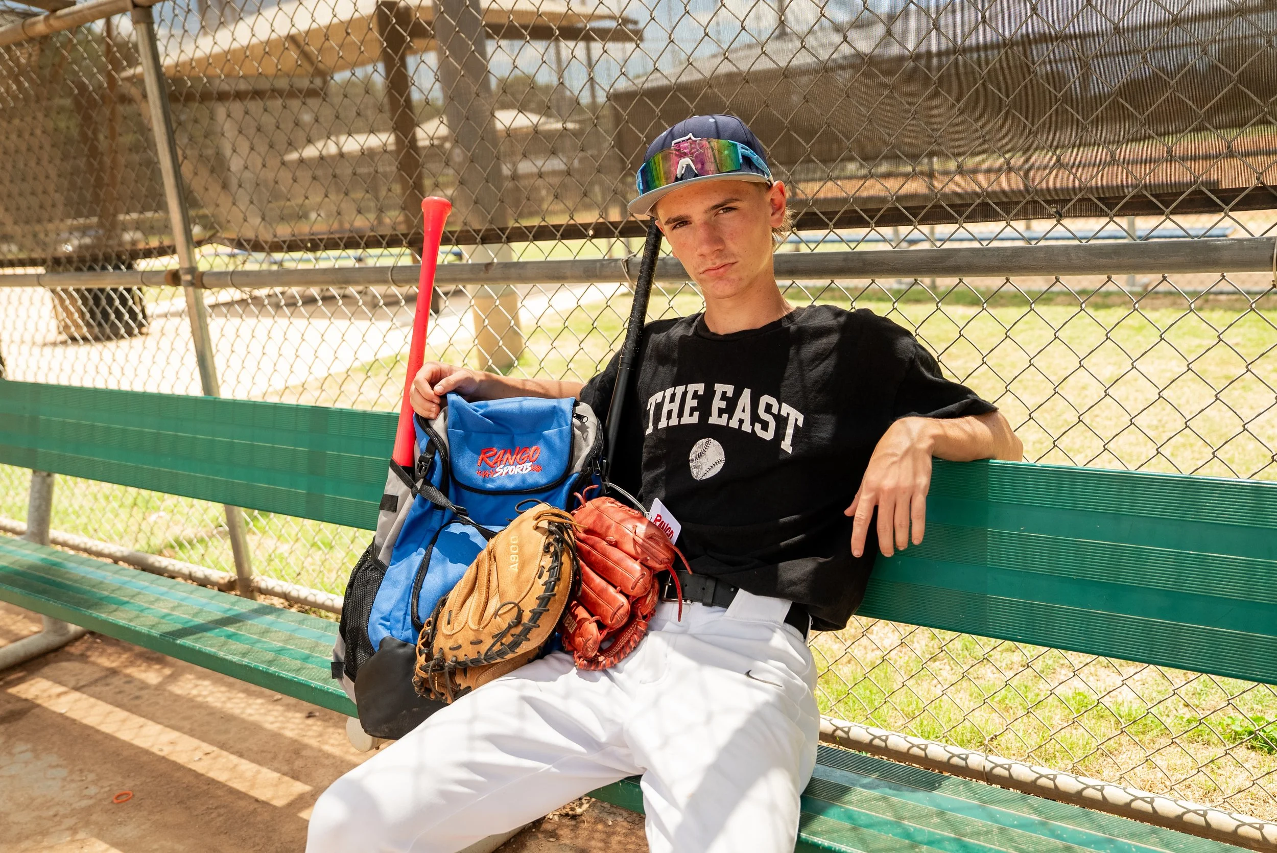Baseball Player in dugout with Rango Sports bag