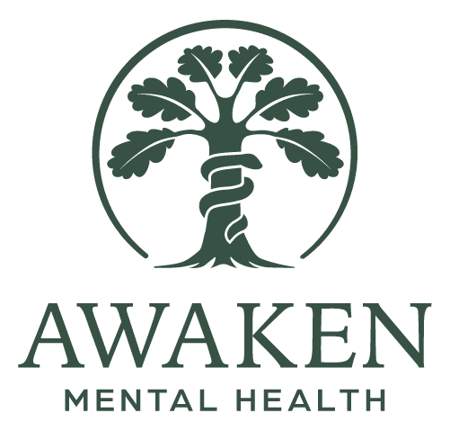 Logo of a tree with a spiral wrapped around the trunk, encircled by a ring, with the words 'AWAKEN MENTAL HEALTH' below.