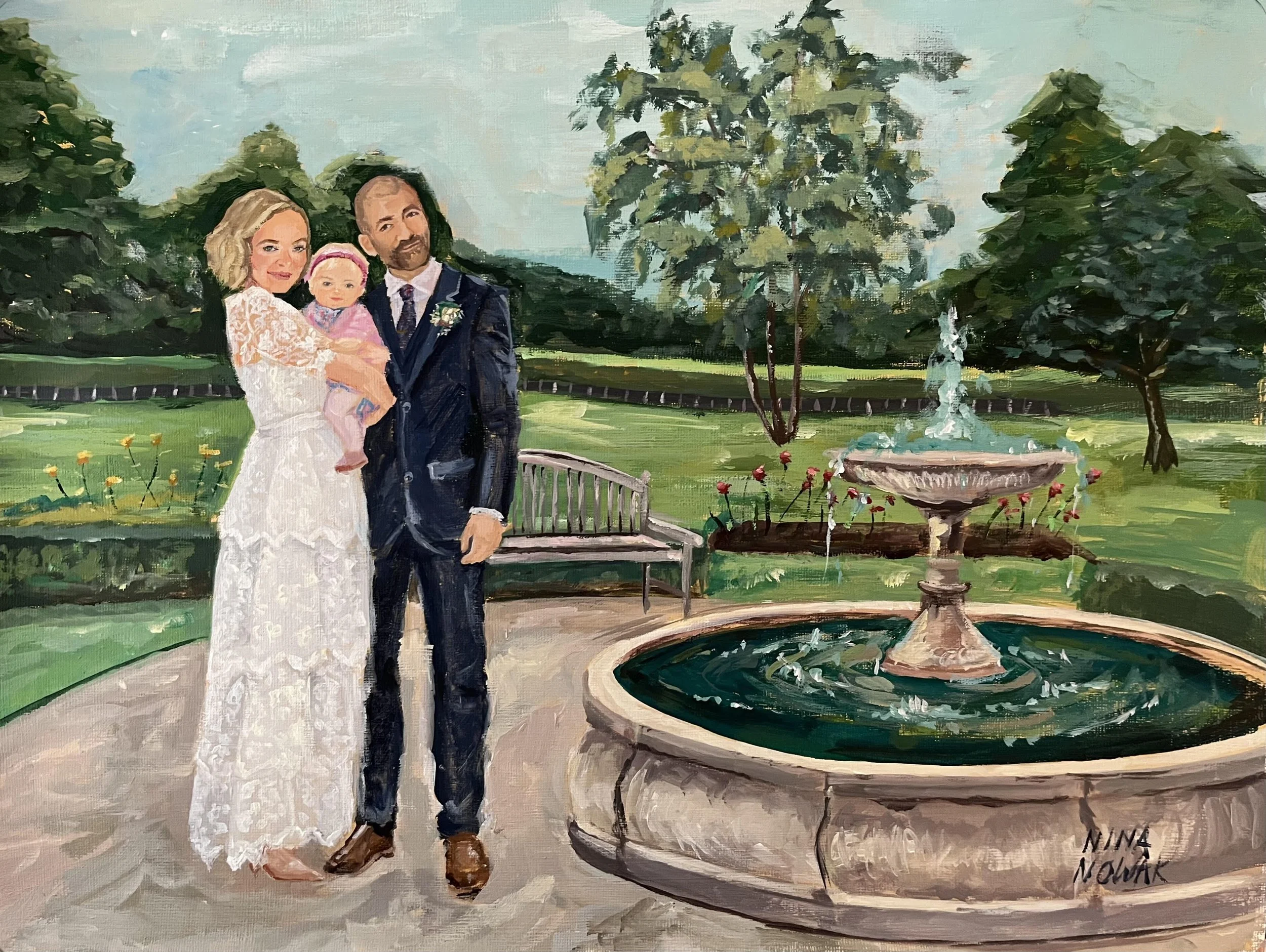 An oil painting depicting a family of three standing in front of a fountain in a lush garden. The woman has blonde hair and is wearing a white lace dress, holding a young girl in pink. The man has dark hair and a beard, dressed in a suit with a bouto
