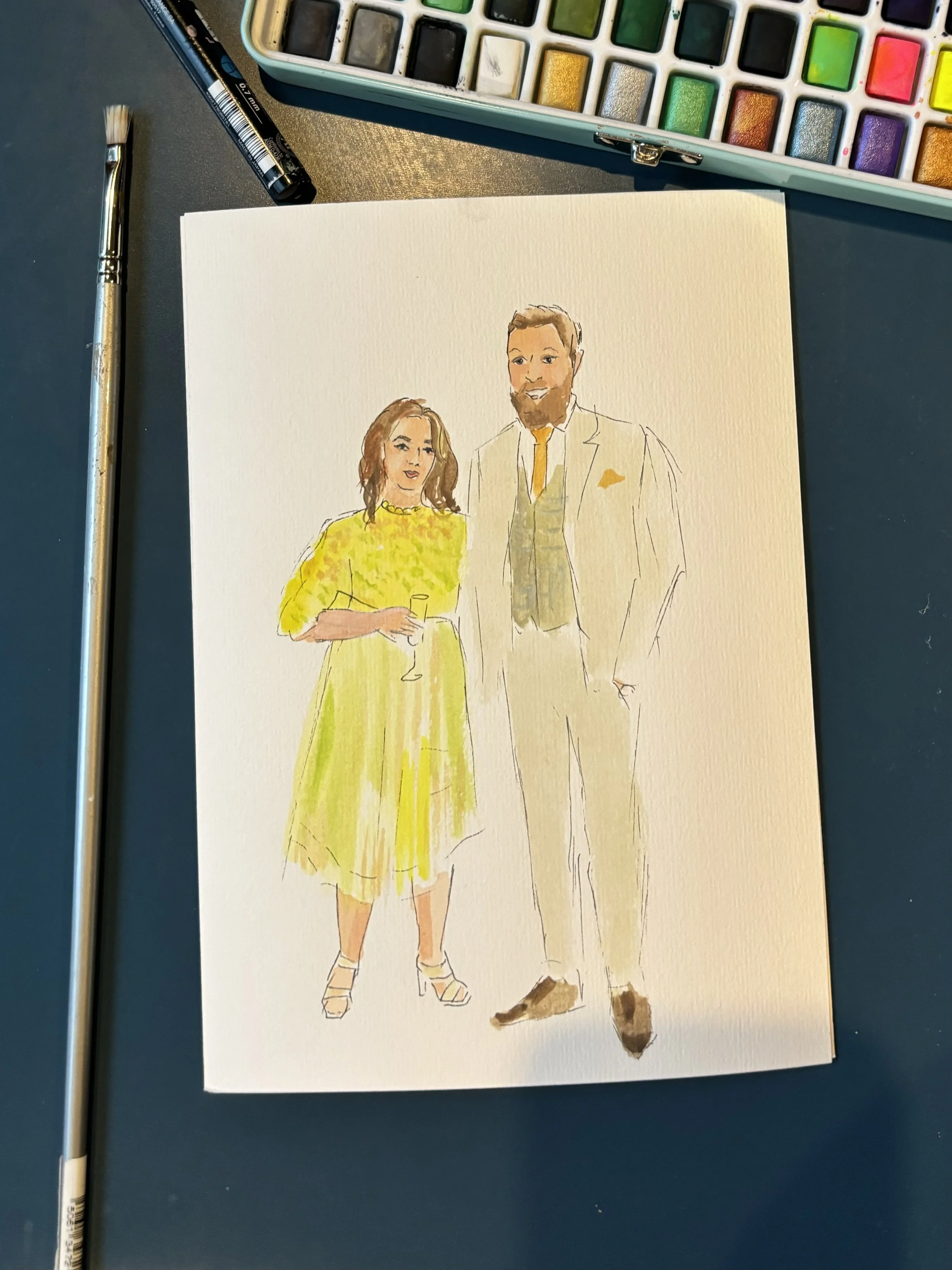 A watercolor painting of a man and woman dressed in formal attire, standing together. The woman wears a yellow dress and holds a glass, while the man wears a light-colored suit with a yellow tie and pocket square.