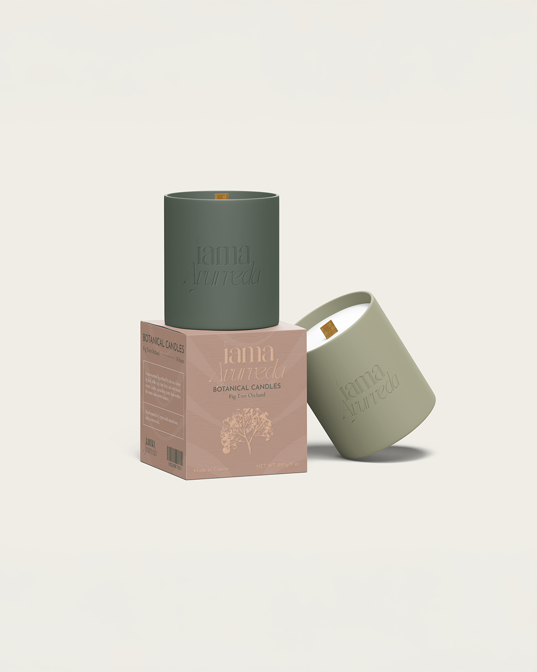 Two scented candles in green and beige containers, one on a pink box, labeled 'Iama Ayurveda Botanical Candles Fig Tree Orchard,'  Beef Design Studio, Brand strategy, Brand identity, visual identity, graphic design