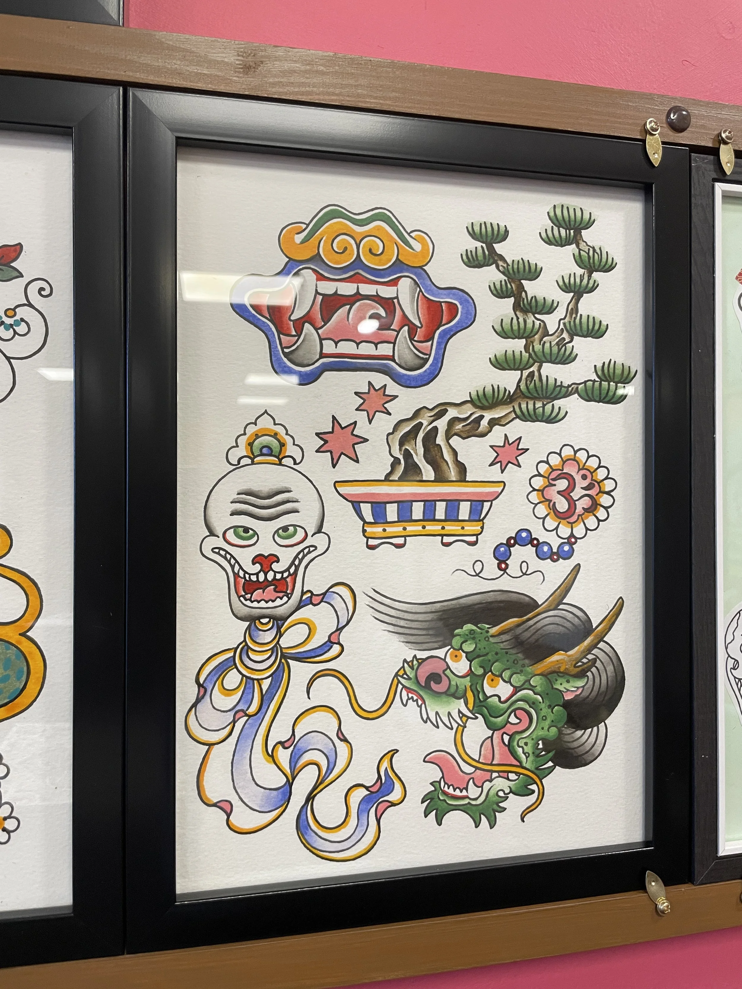 Traditional Japanese tattoo-style artwork featuring a fierce, colorful dragon and a laughing, bald man with green eyes, set against a white background.