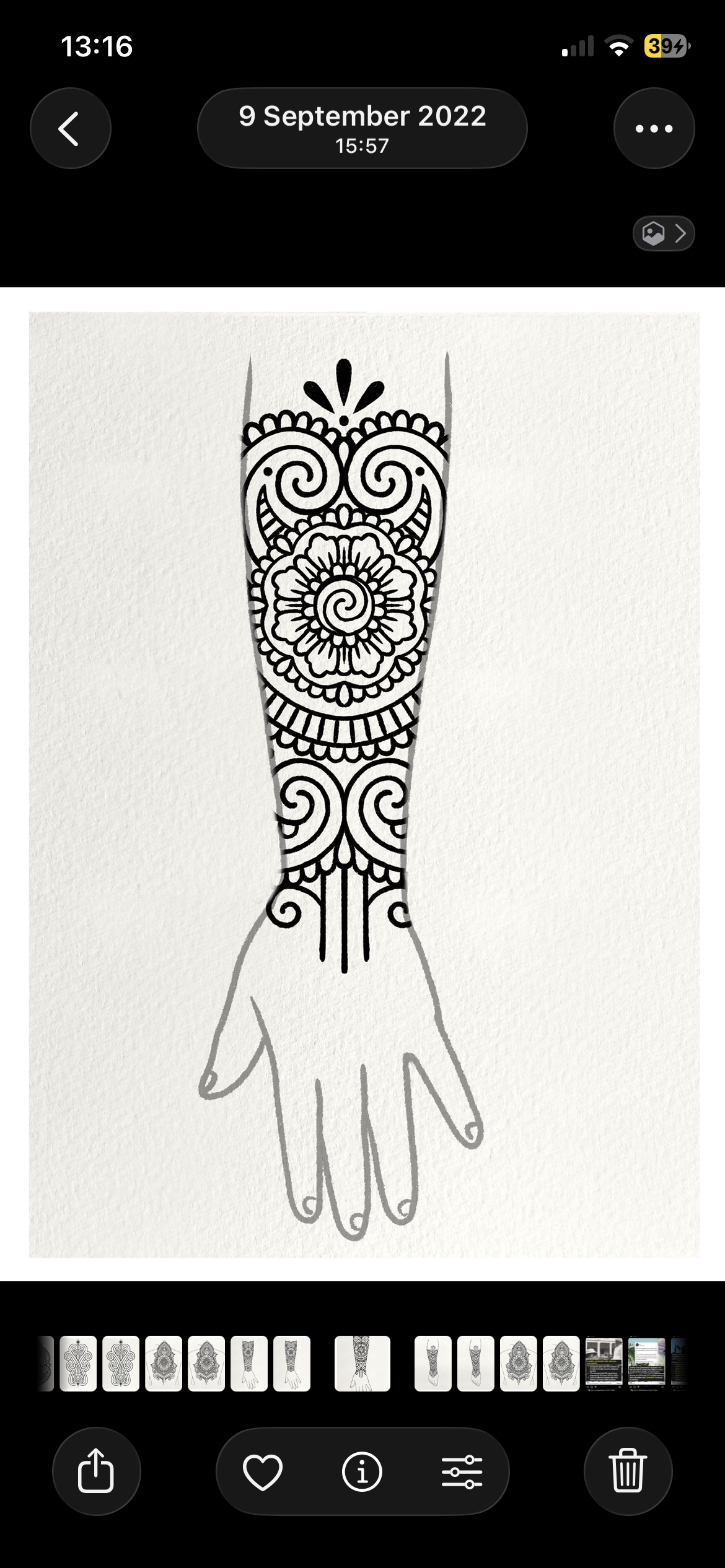 Black and white illustration of a tattoo design on a forearm and hand with intricate swirling and floral patterns.