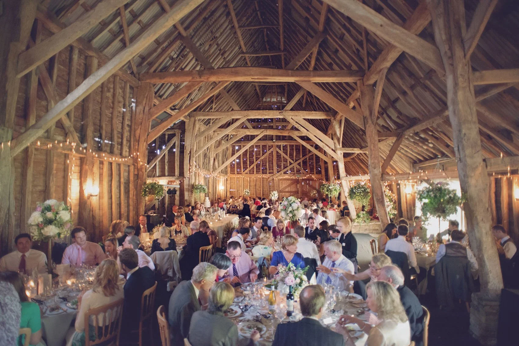 A wedding breakfast underway during a barn wedding in Hertfordshire