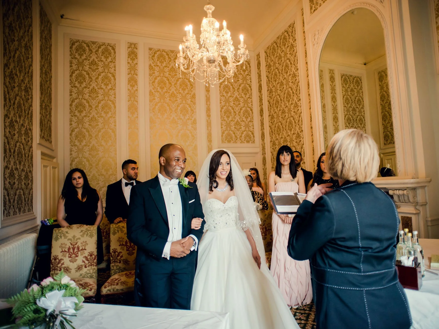 Bride and groom at their micro wedding ceremony in Luton Hoo Hotel in Bedfordshire, with just their closest friends and family as their witnesses