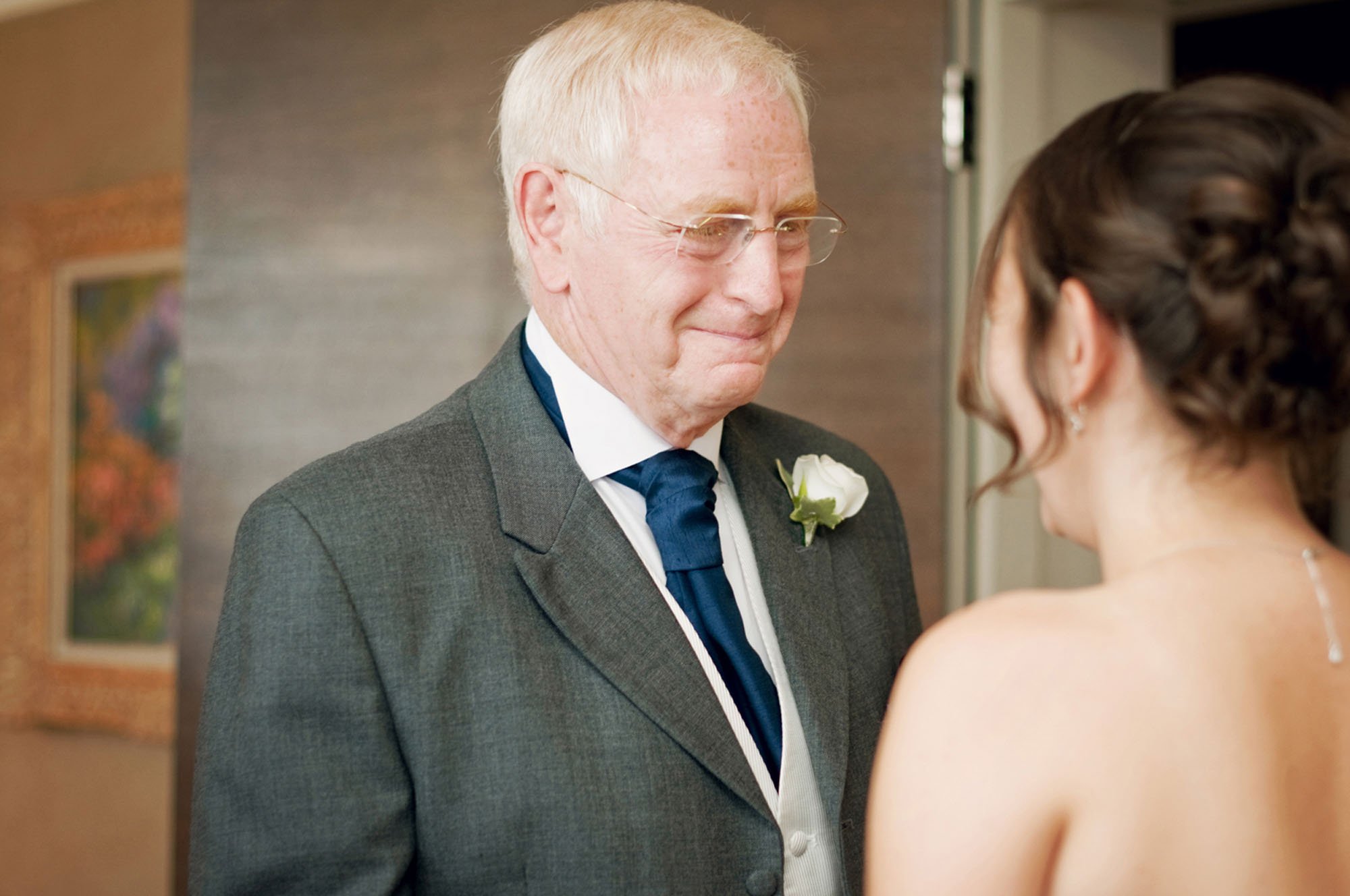 A bride's father looks emotional as he sees his daughter for the first time in her wedding dress, ahead of her wedding in Camden in north London