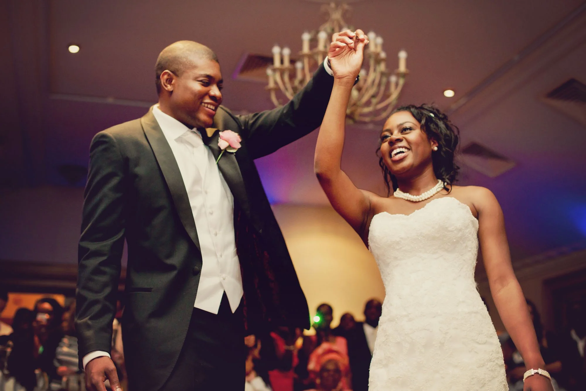 Bride and groom laughing during their first dance at Pennyhill Park in Surrey
