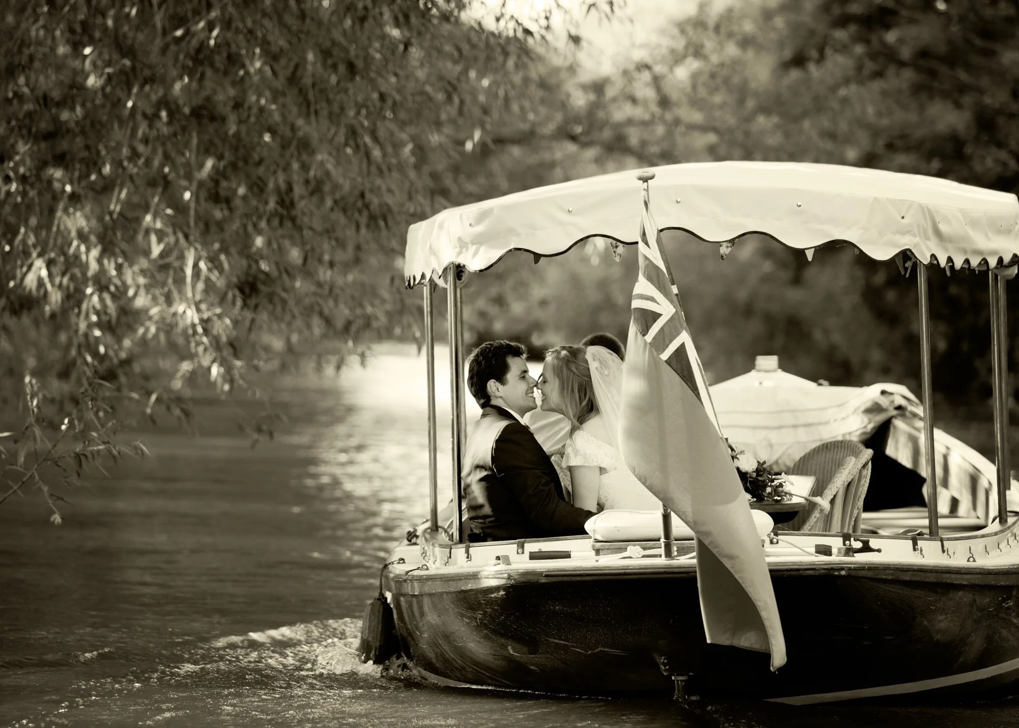 Bride and groom on a private boat ride on the River Cherwell after their micro wedding in Oxford, on their way to the reception at The Perch in Oxford