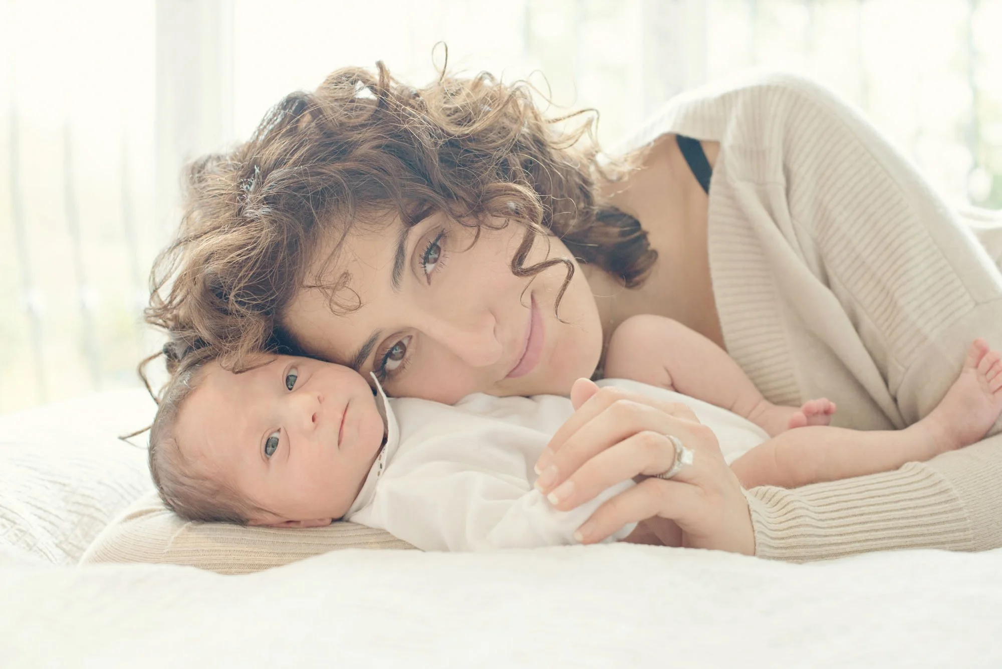 Beautiful and serene new mother with her newborn baby