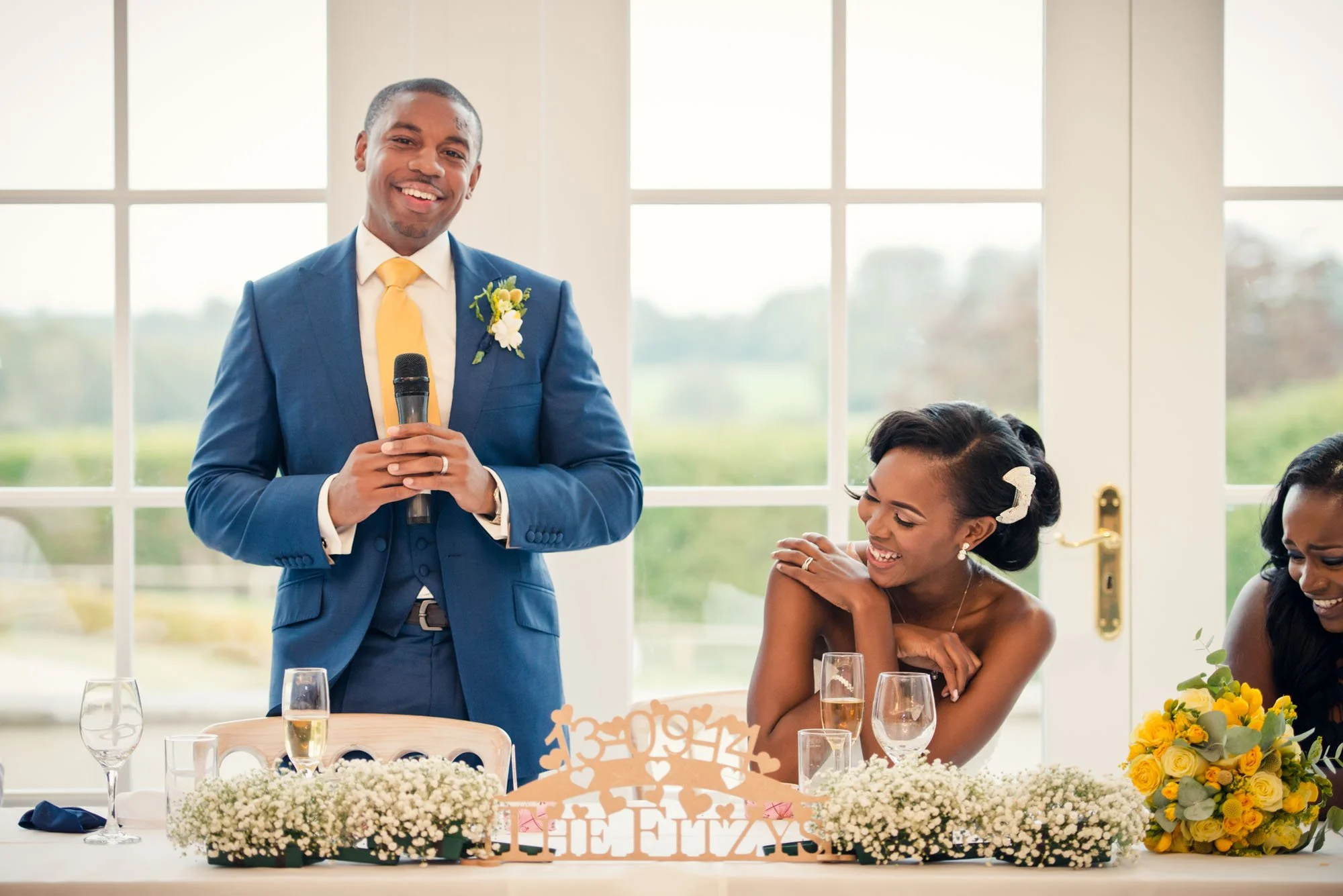 Bride laughs at groom's speech at Froyle Park in Hampshire