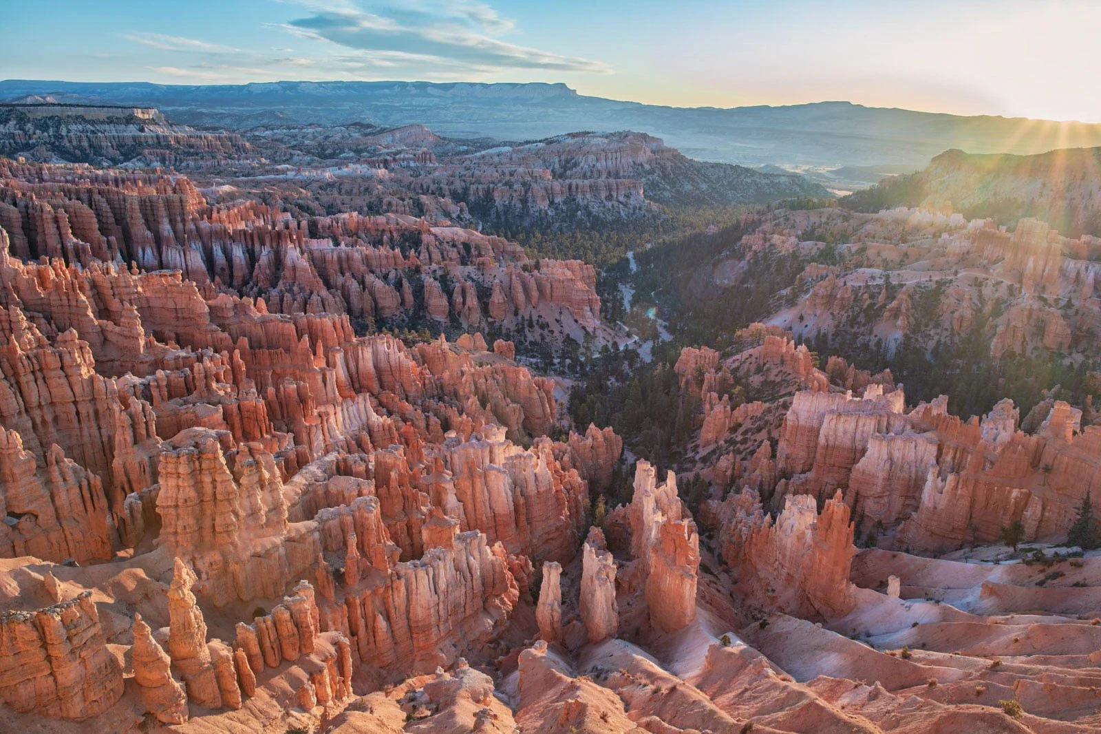 Sunlight over the colorful hoodoos and canyons of Bryce Canyon National Park at sunset.