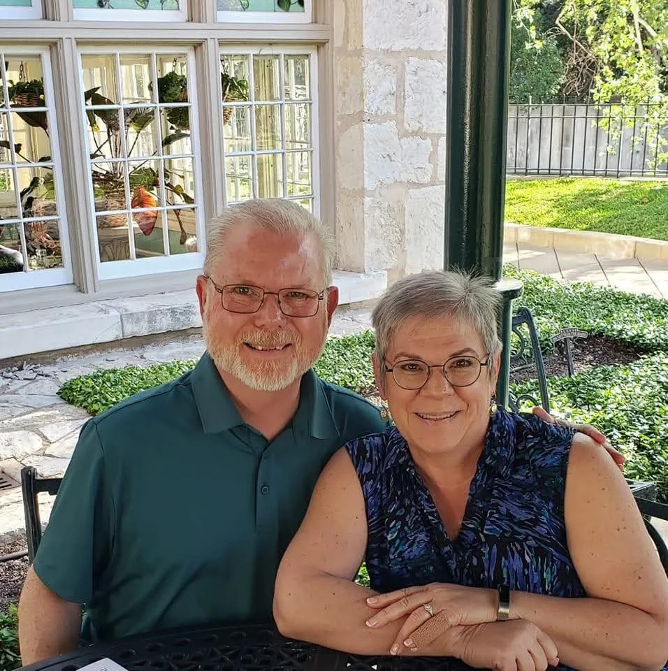 Kenny and Susan, founders of Mended Mentors, smiling together outdoors.