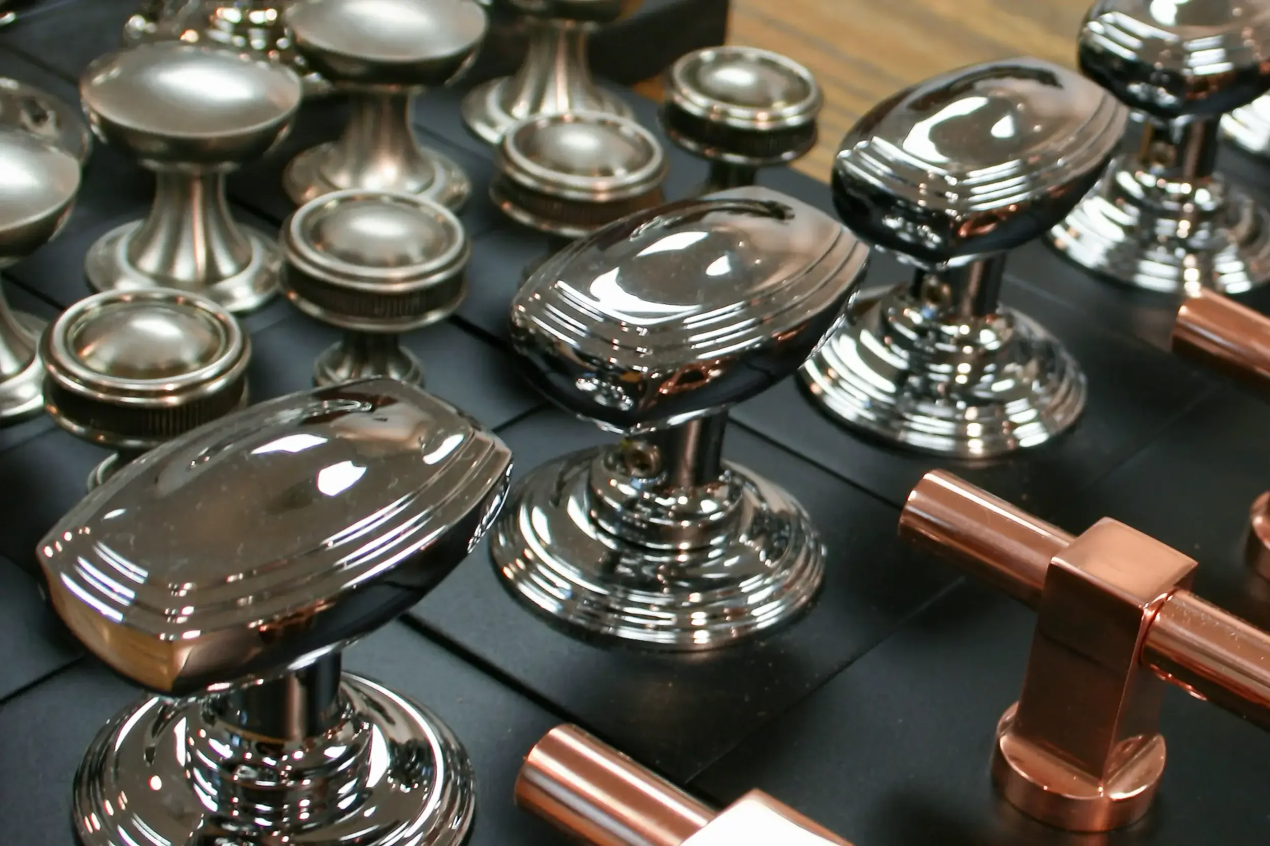 Close-up of drawer pulls with a shiny electroplated finish.