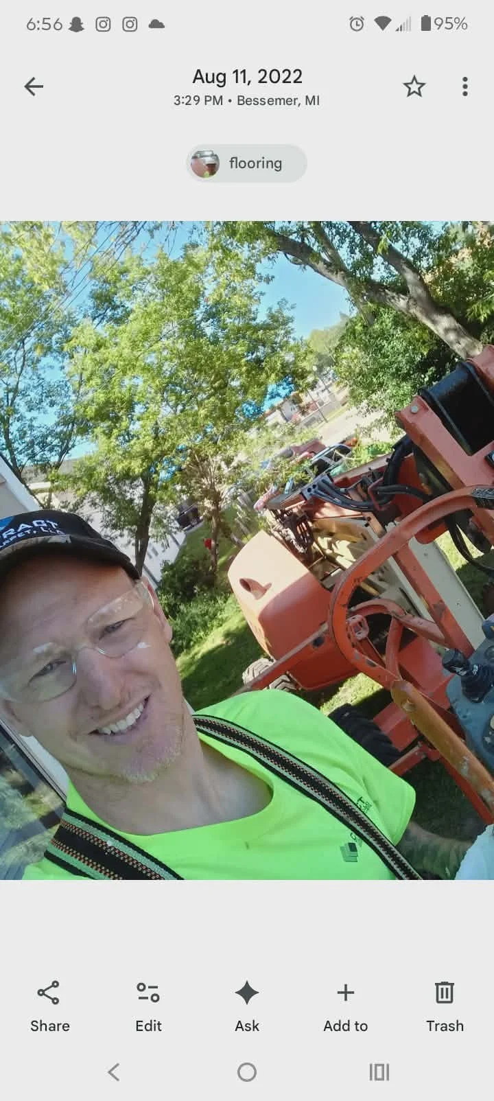 Painter preparing to go up in a JLG lift to paint an exterior of a house in Bessemer, MI.