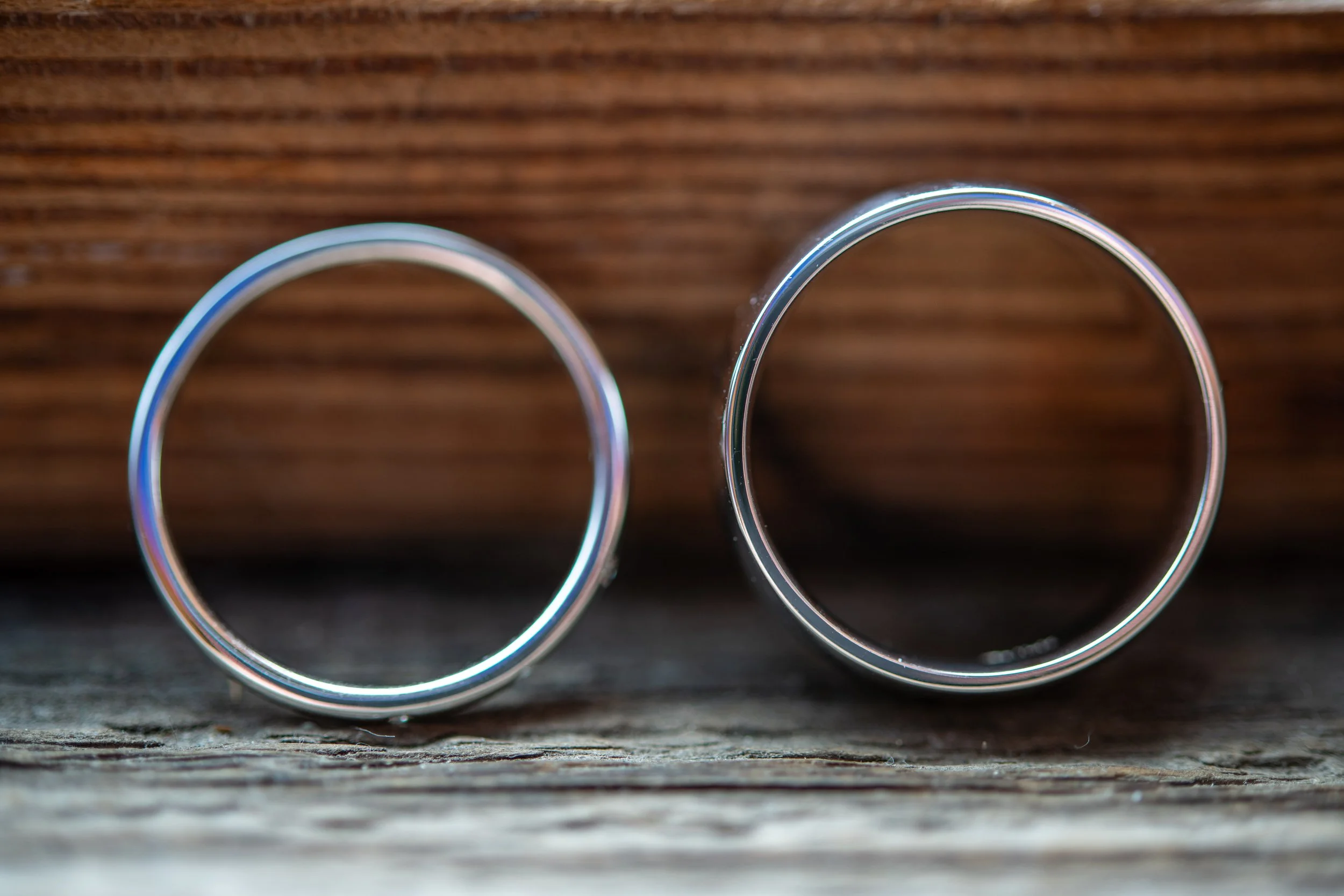 Two metal rings on a wooden surface.