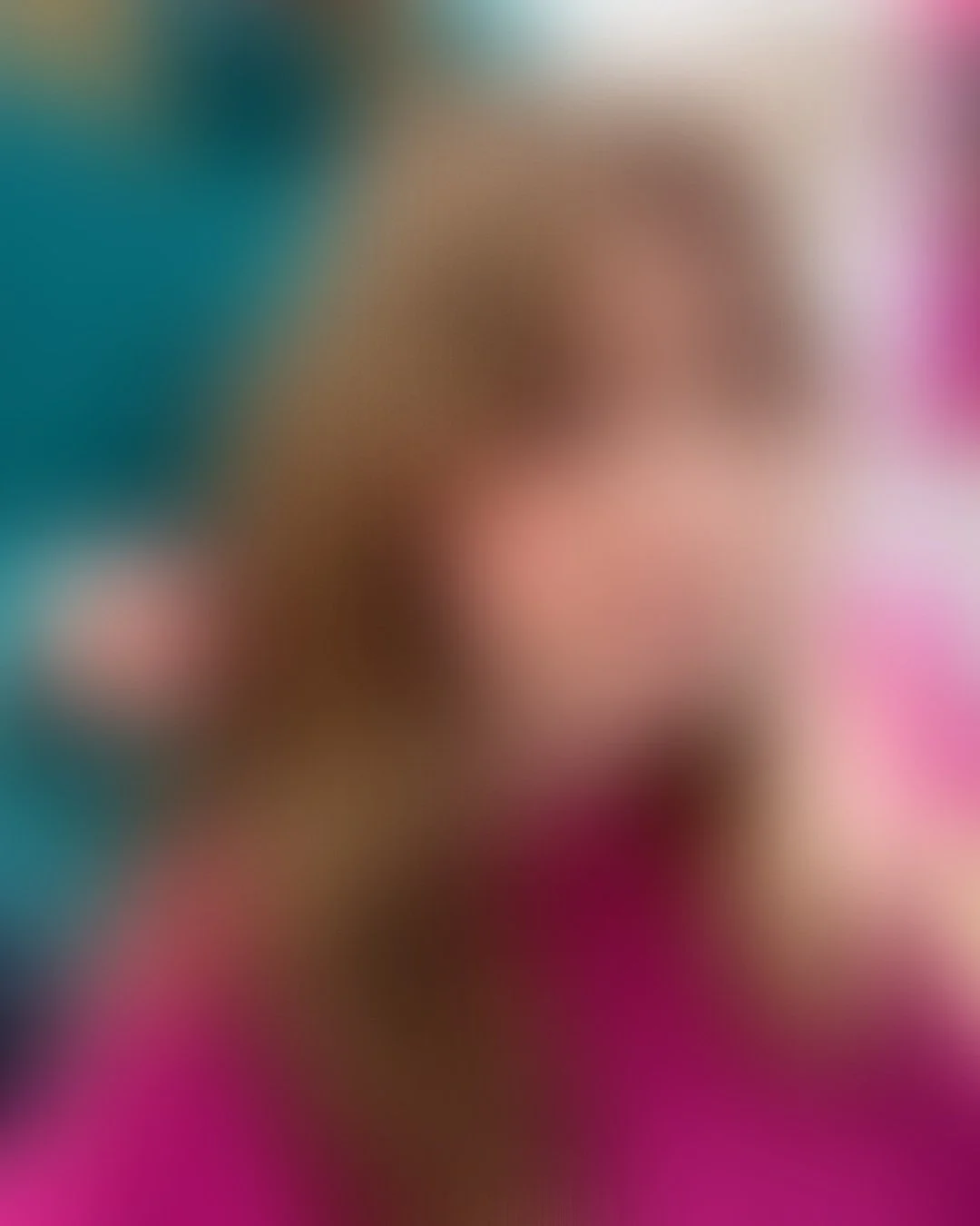 The image is highly blurred, making it difficult to discern specific objects or details.