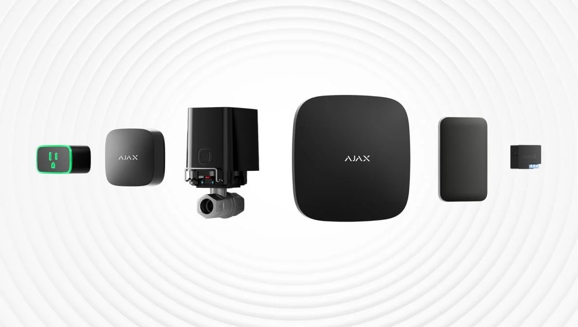 A collection of various black smart home gadgets laid out on a white background.